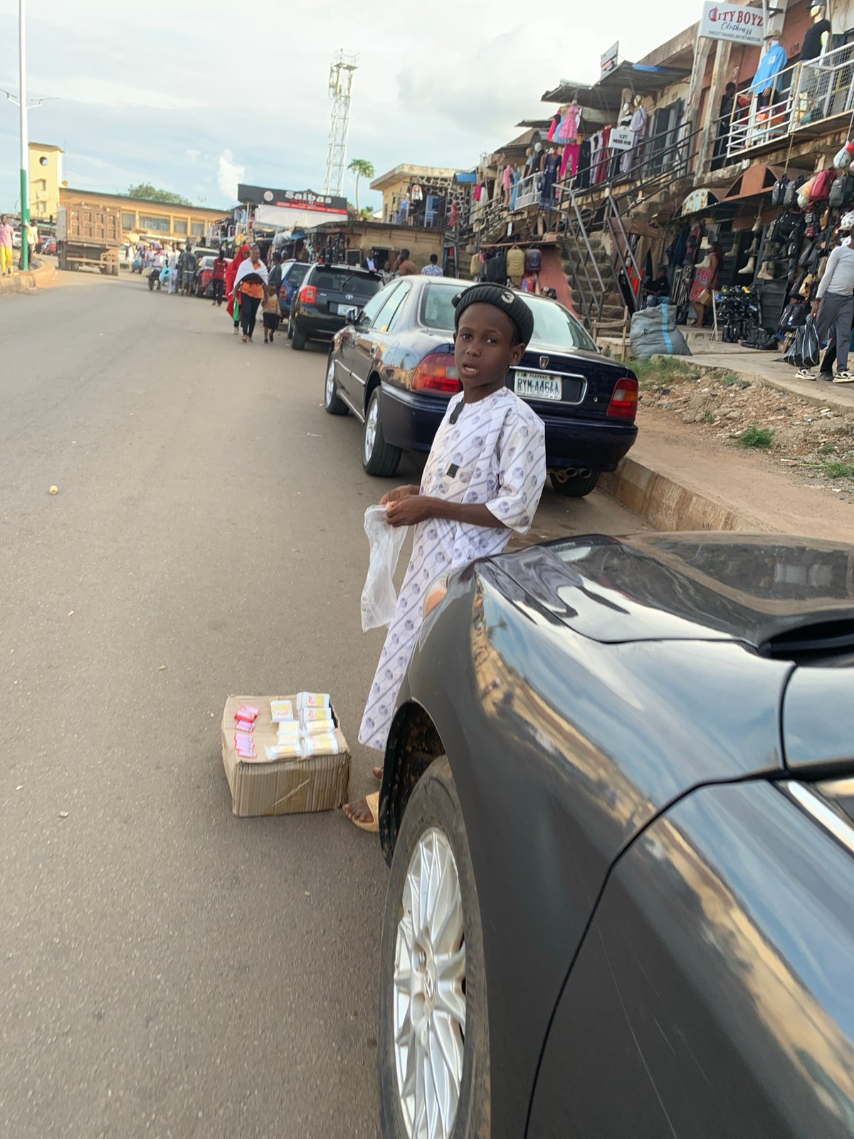 Afternoon foot traffic on a commercial street in Jos, Nigeria