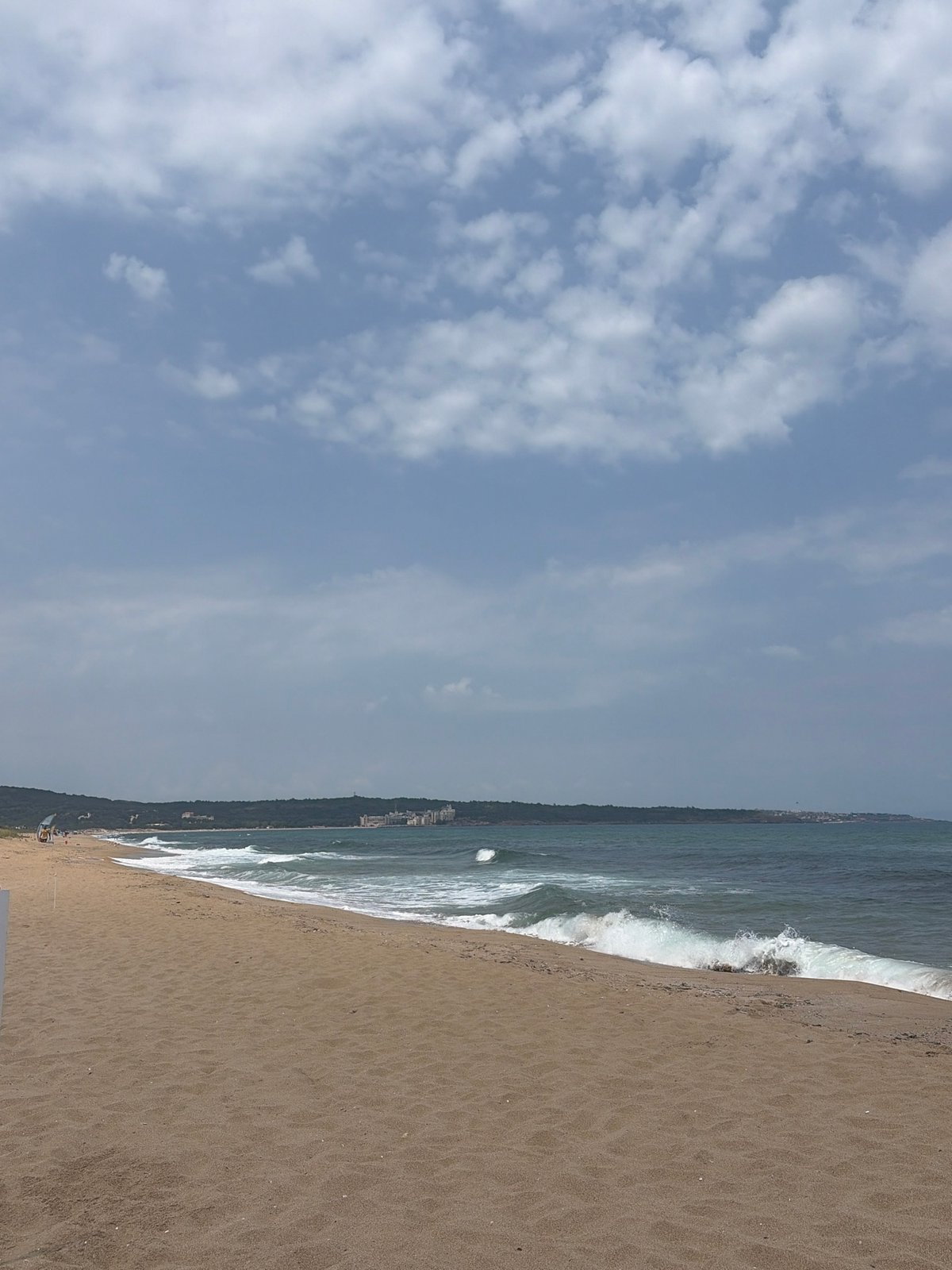 Laid-back beach day with waves, shade, and shoreline strolls