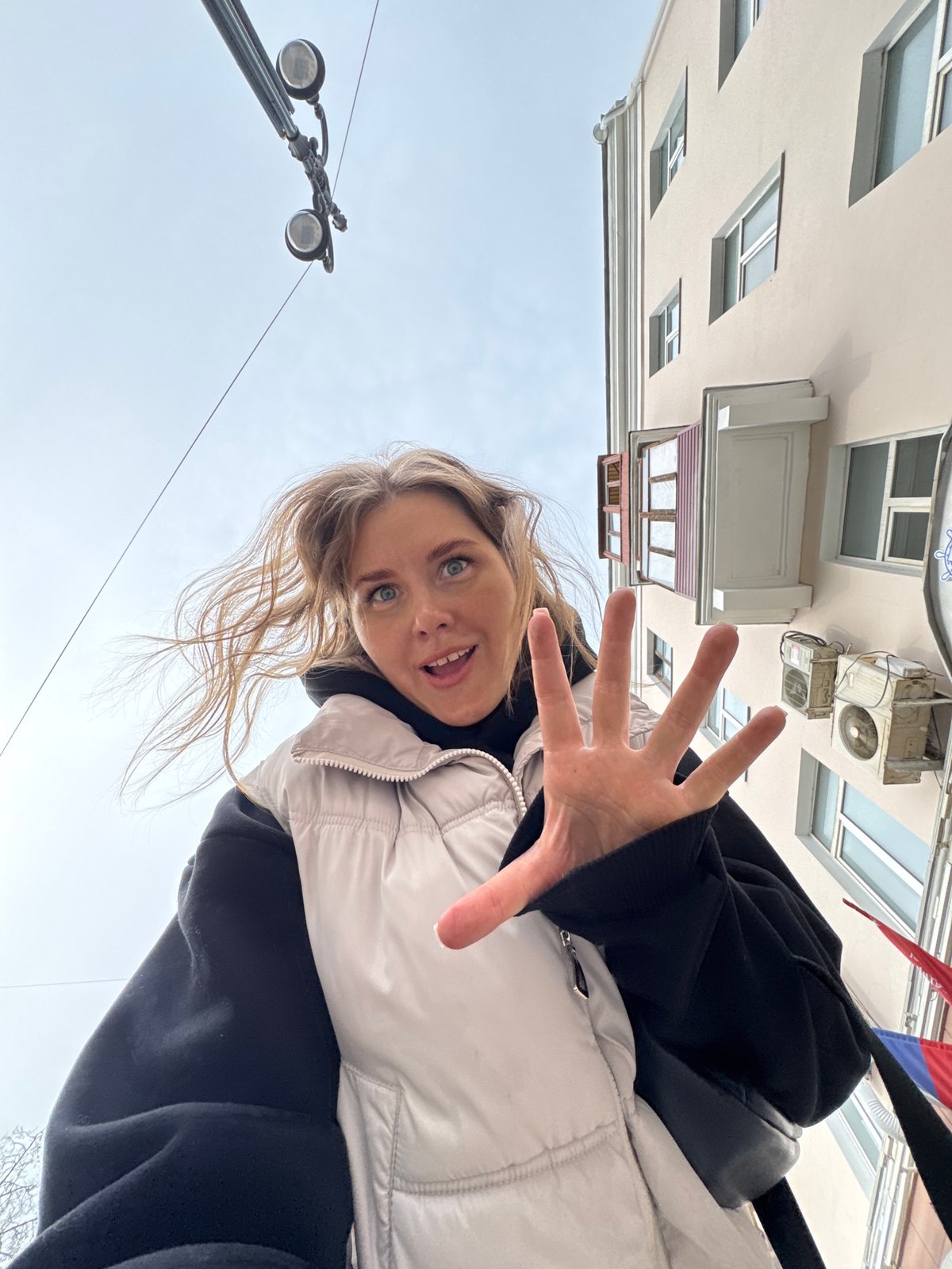 Woman takes selfies near construction work in Perm, Russia