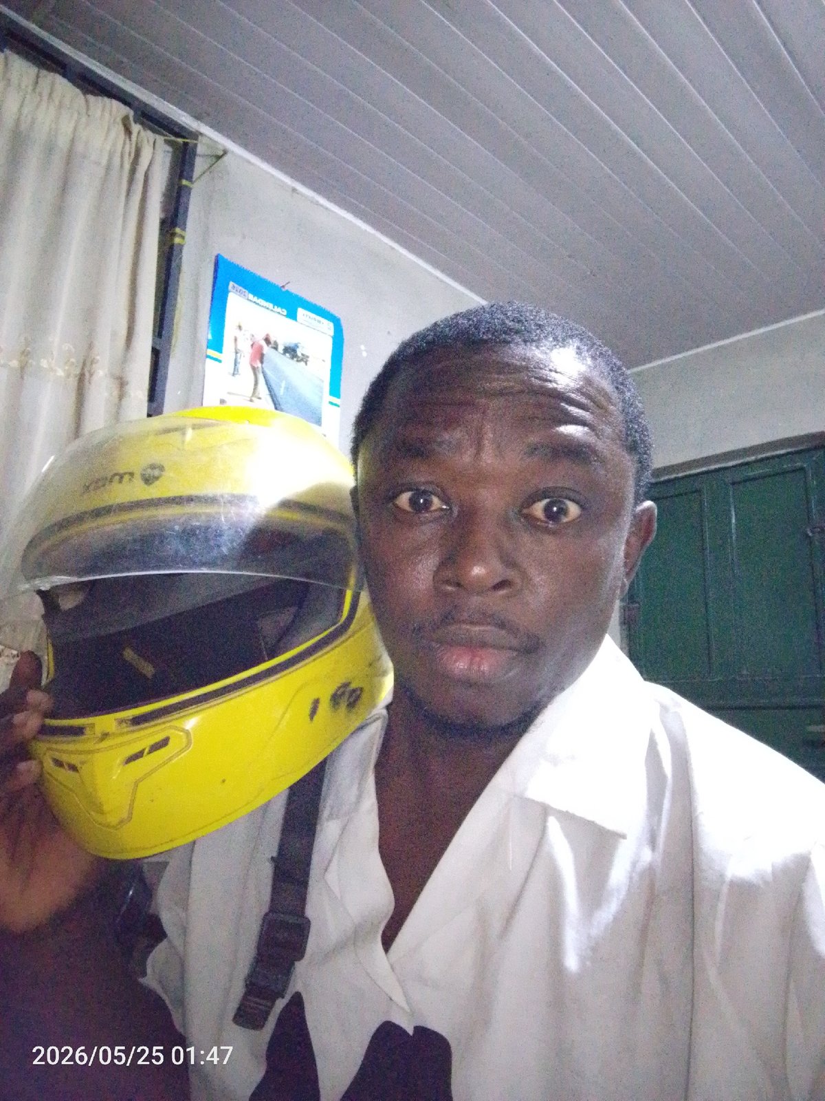 Person with yellow motorcycle helmet photographed in Lokoja, Nigeria