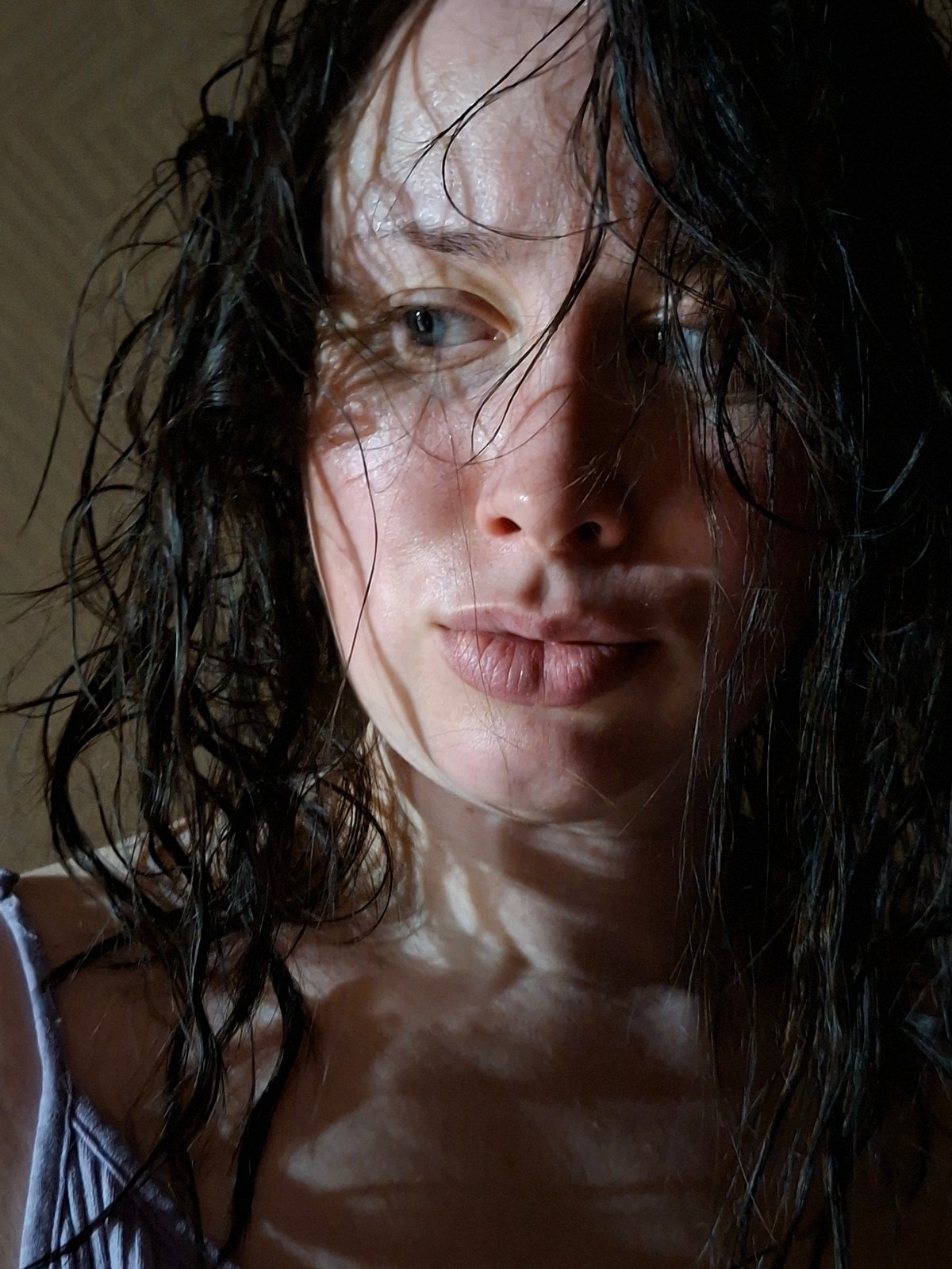 Unidentified person with wet hair captured in tilted close-up