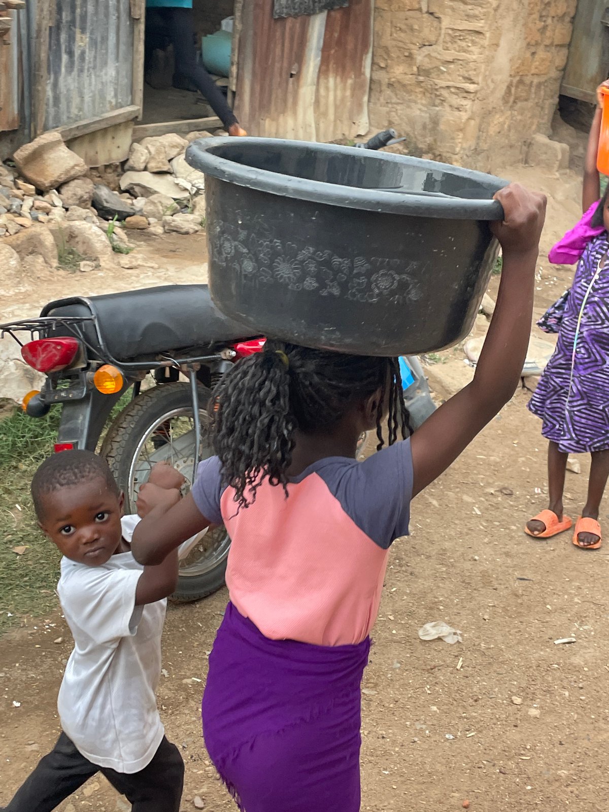 Daily life captured in Jos: children and vendors carrying goods