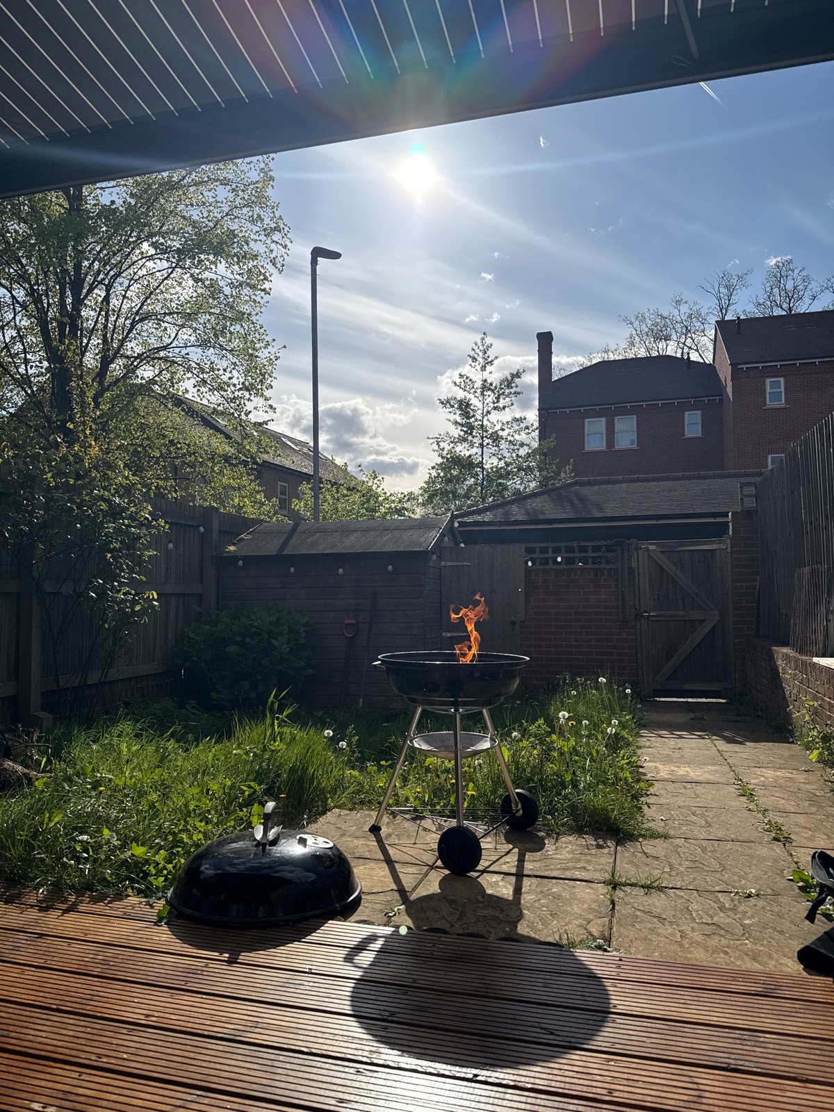 Barbecue grills burning in London garden on sunny afternoon