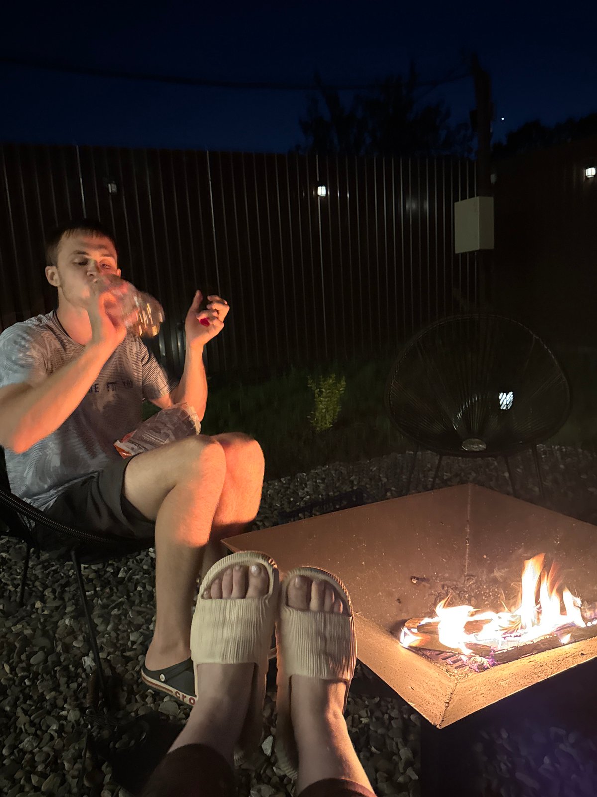 Backyard fire pit gathering with marshmallows in Starokorsunskaya