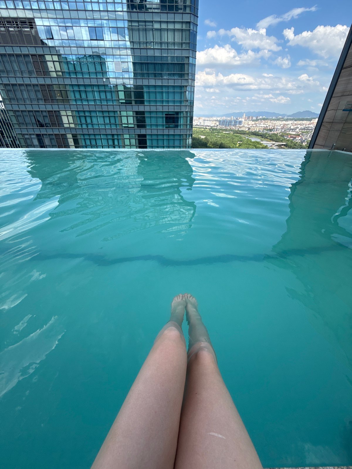 Rooftop infinity pool day in Yiwu, city views included