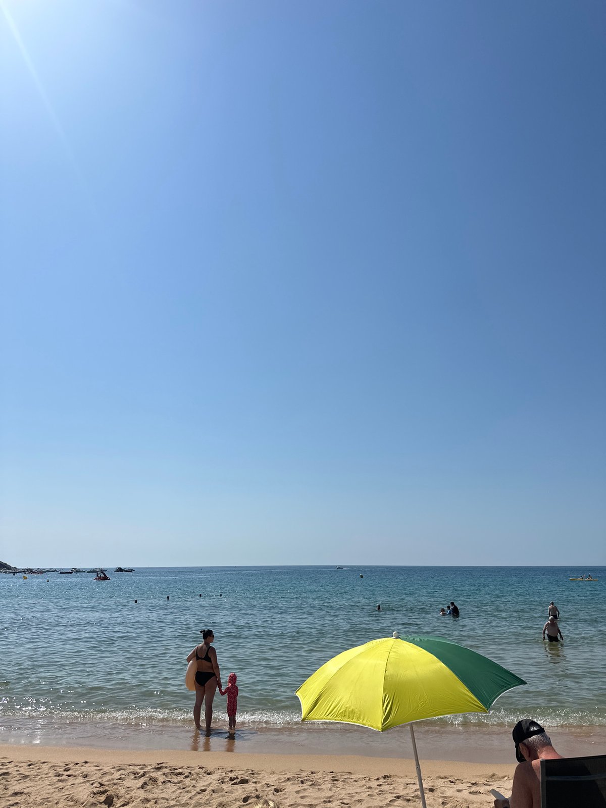 Crowded summer beach day at Sant Feliu de Guíxols, Costa Brava