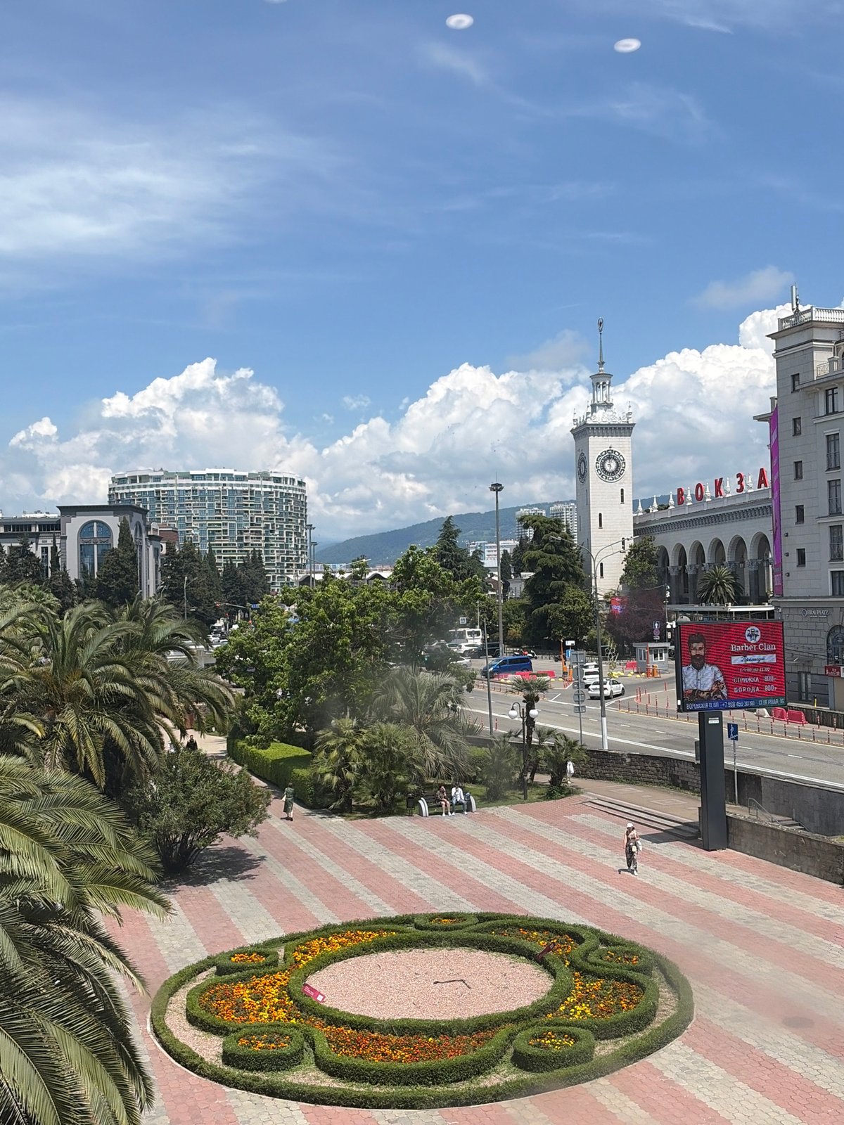Individual documents Sochi landmarks and takes selfies during morning walkabout