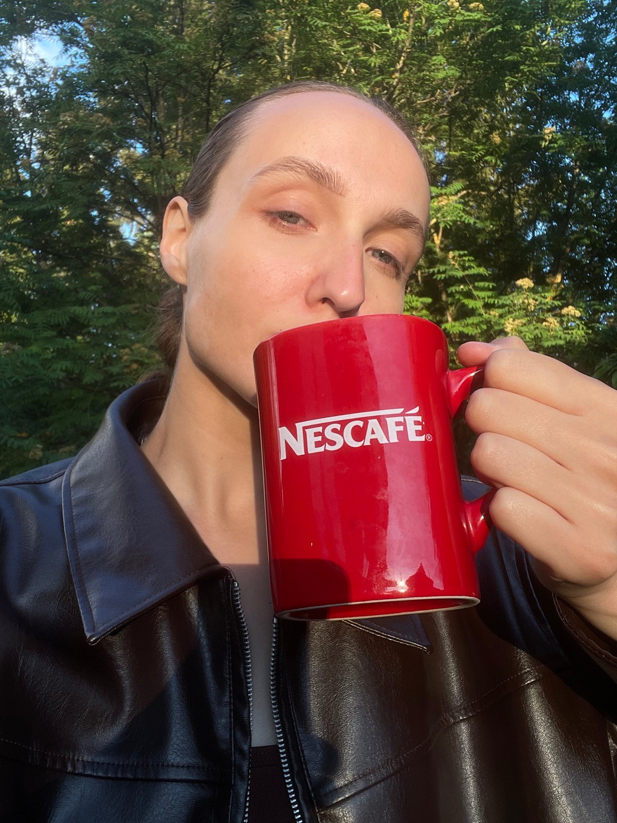 Woman enjoys coffee outdoors in Sharkan, Russia afternoon