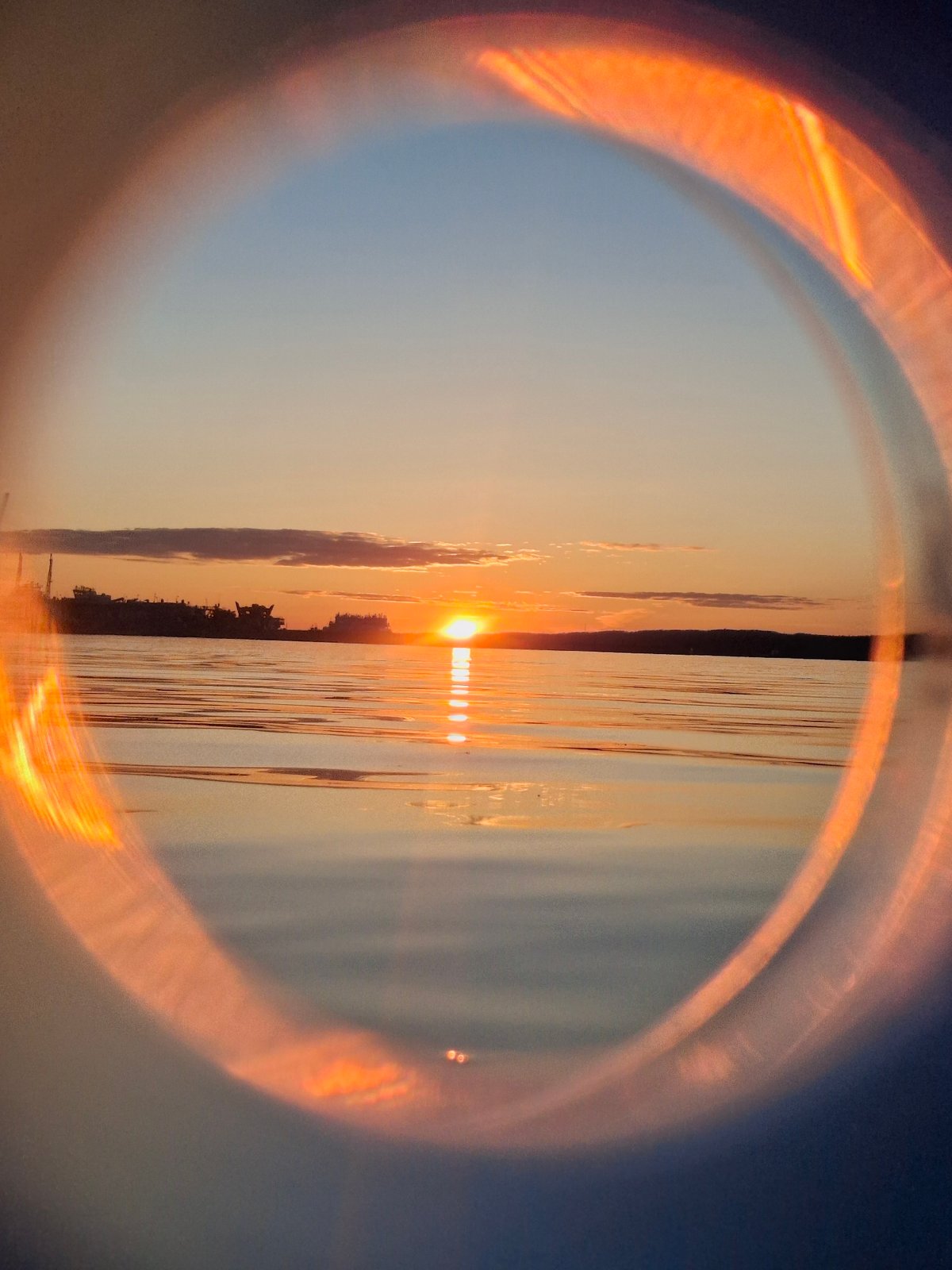 Sunset over Kama River observed through makeshift lens in Chaikovsky
