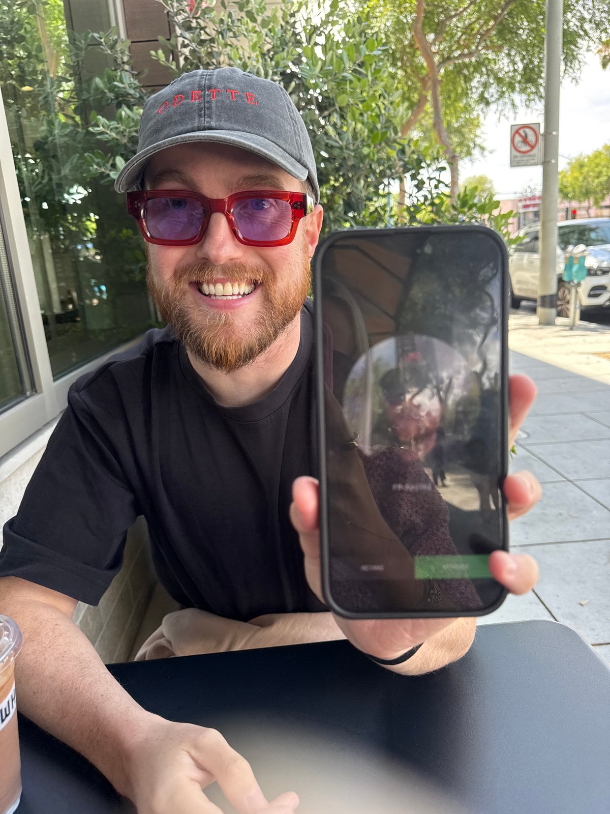Man with smartphone, Erewhon drinks photographed in West Hollywood