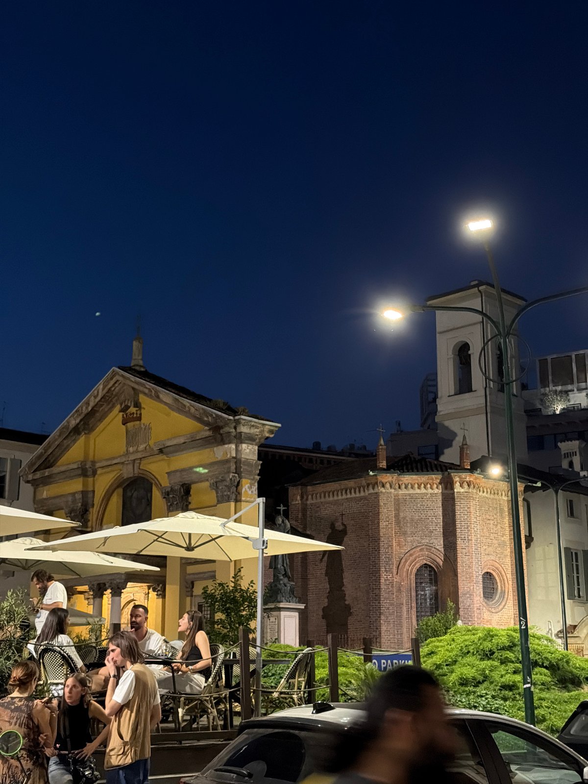 Evening outdoor dining scene documented in Milan, Italy