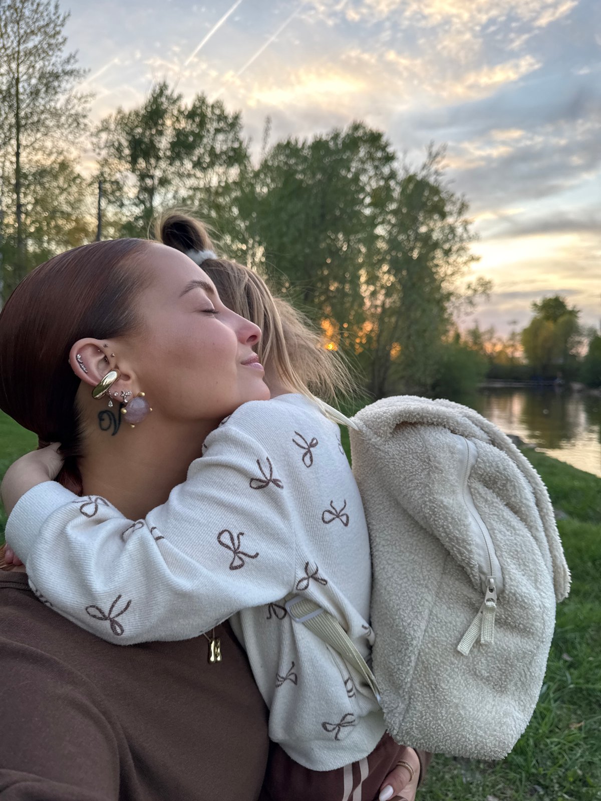 Family enjoys sunset by Kama River in Chaikovsky