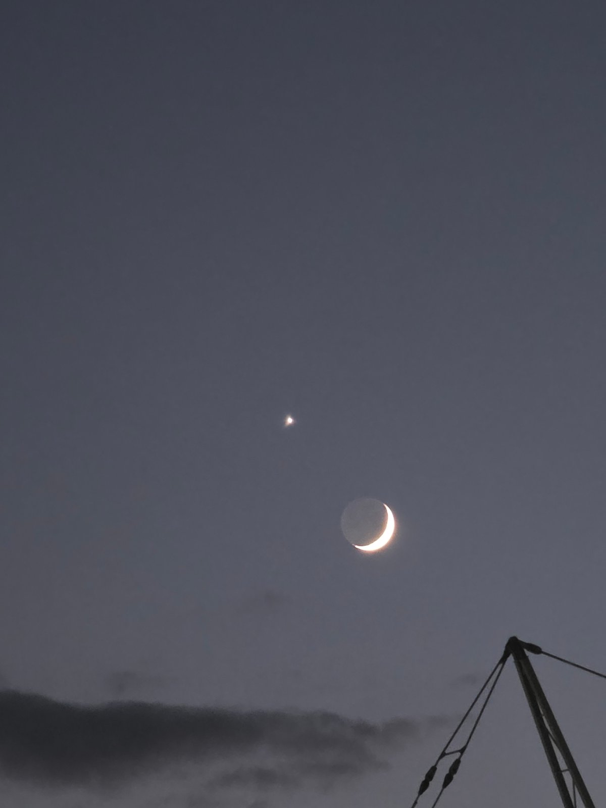 Crescent moon and star at dusk over Podgorica