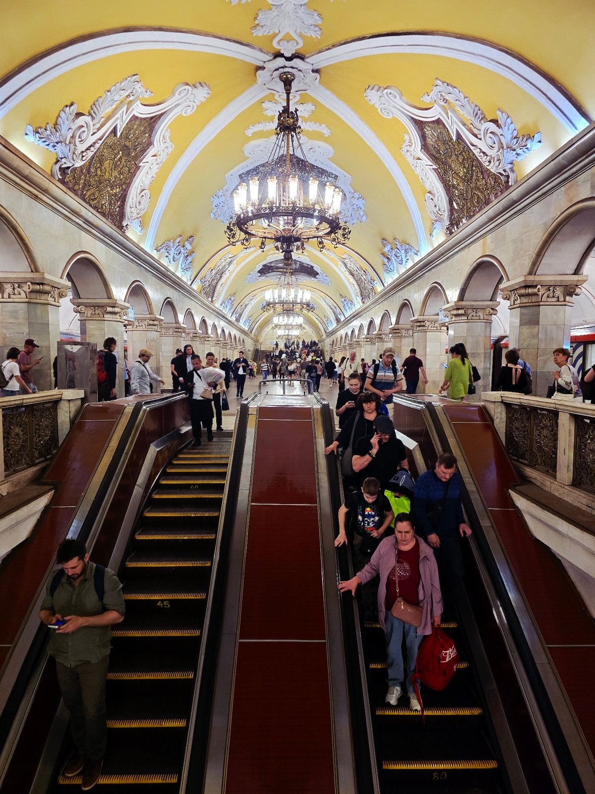 Moscow Metro Commuters Navigate Ornate Komsomolskaya Station Escalators