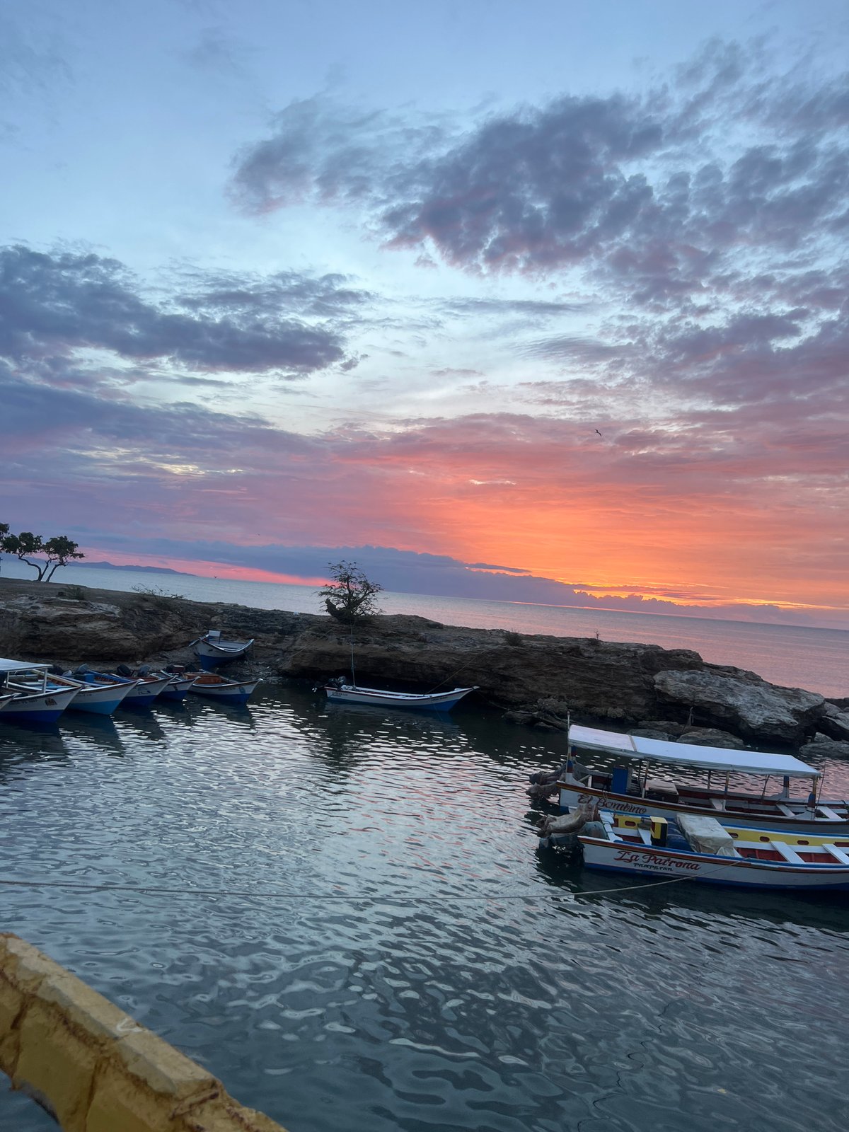 Sunset along Juan Griego's waterfront, boats and crowds at dusk