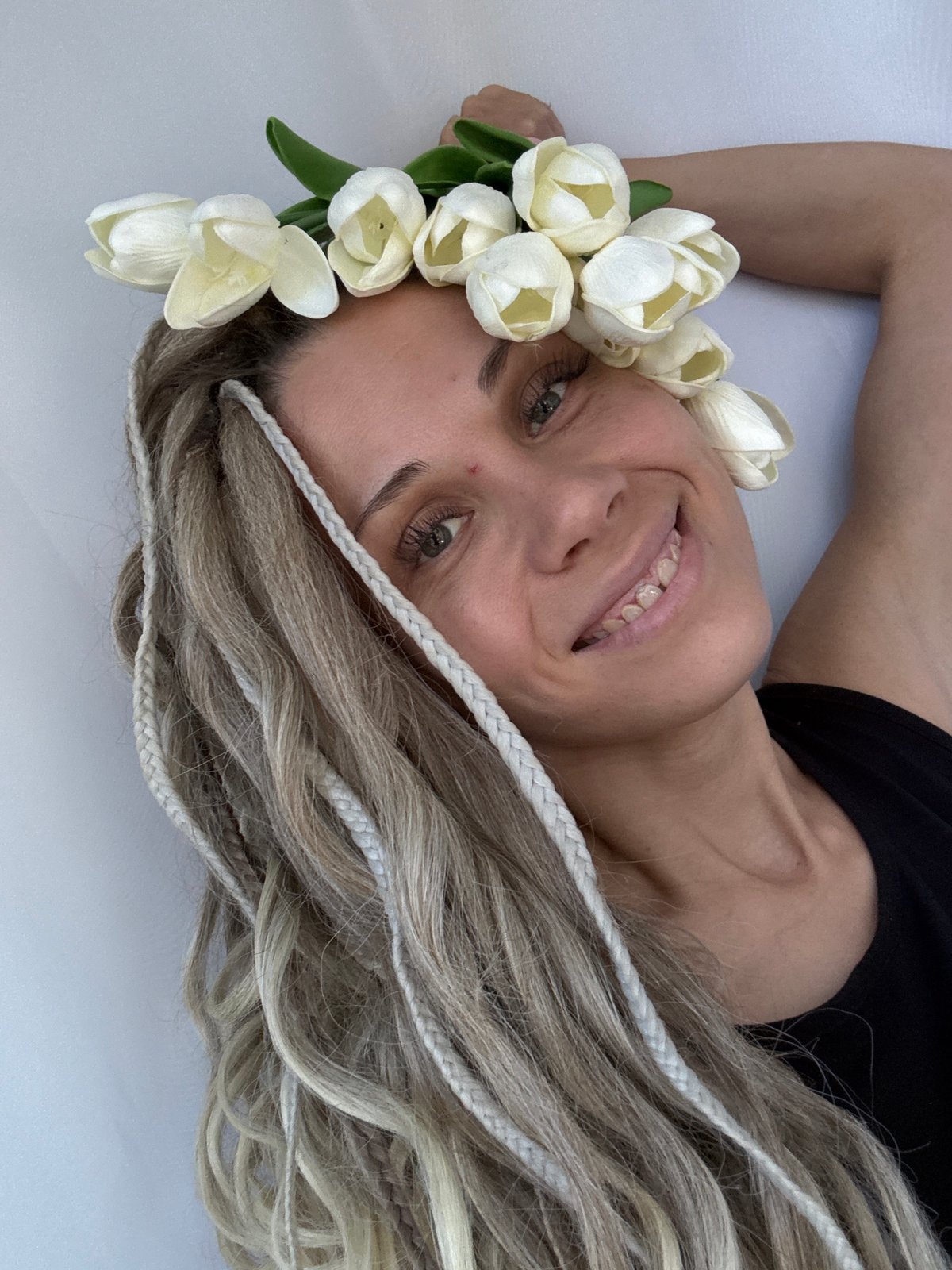 Woman poses for photo session with flowers in Rusanovo