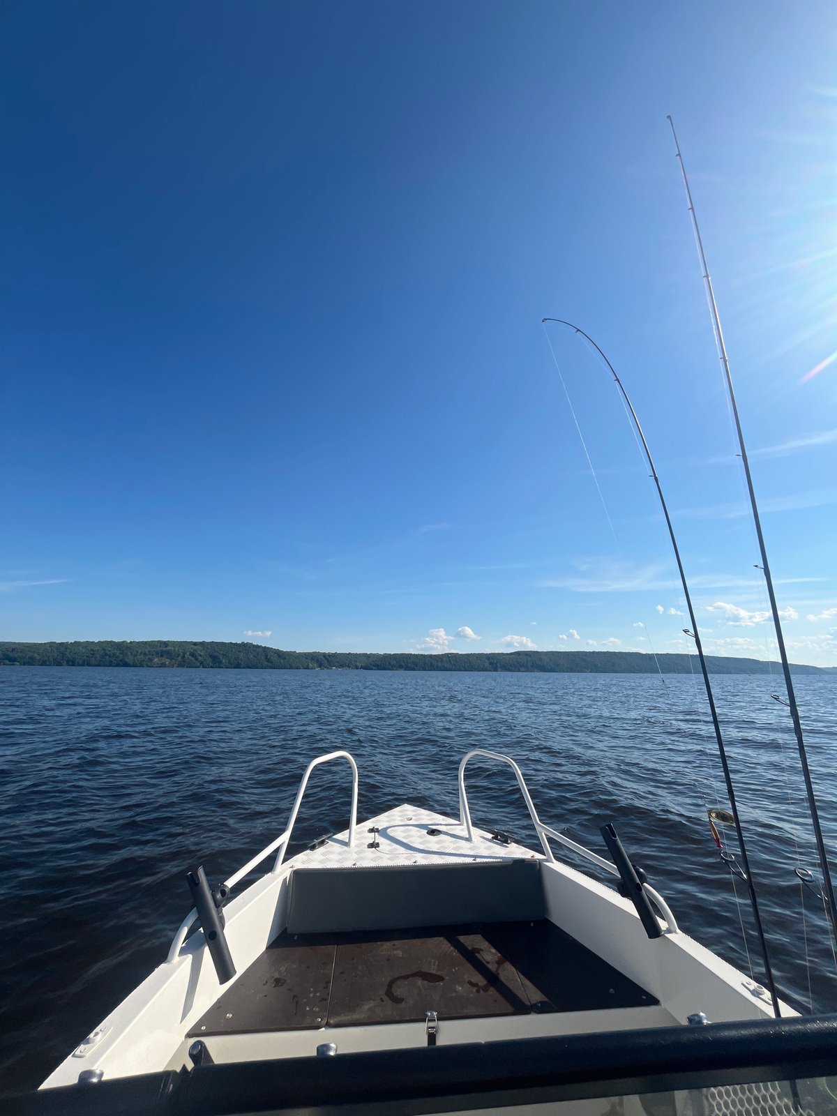 Fishing boat out on sunny Russian lake waters at midday