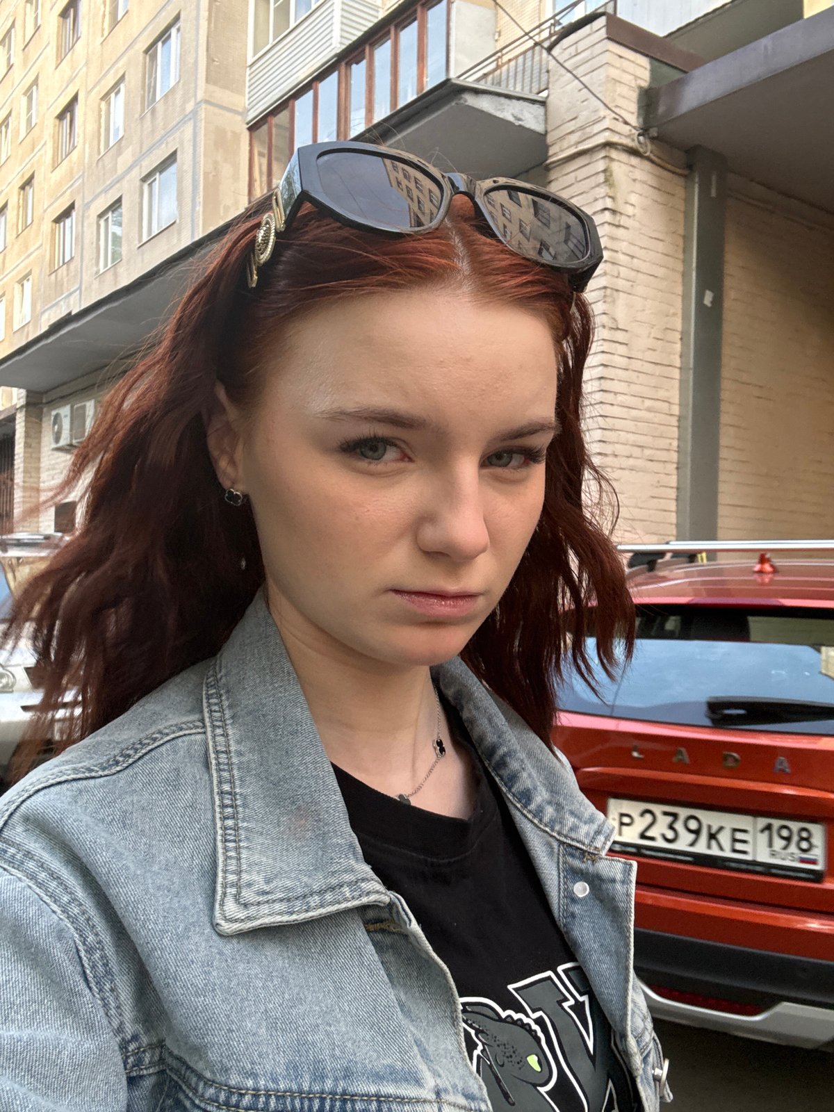 Woman poses for photos on Vsevolozhsk street