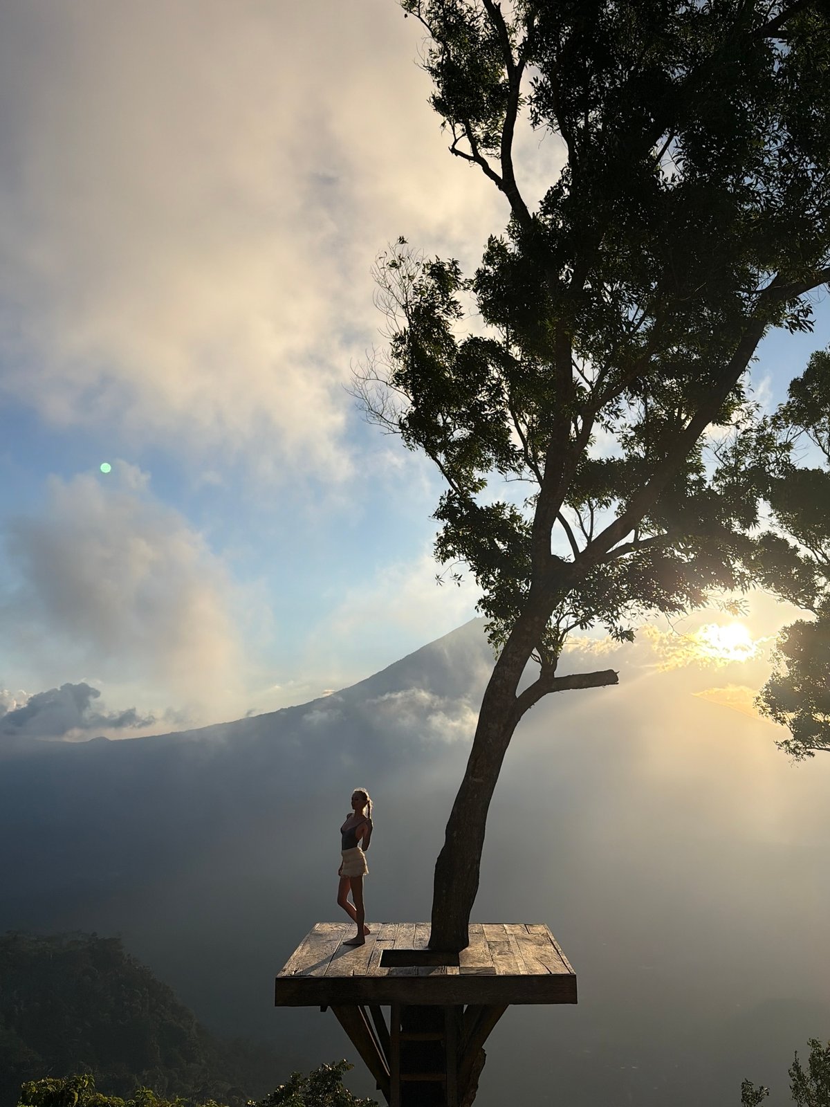 Clifftop tree platform overlooks misty mountain valley in Abang