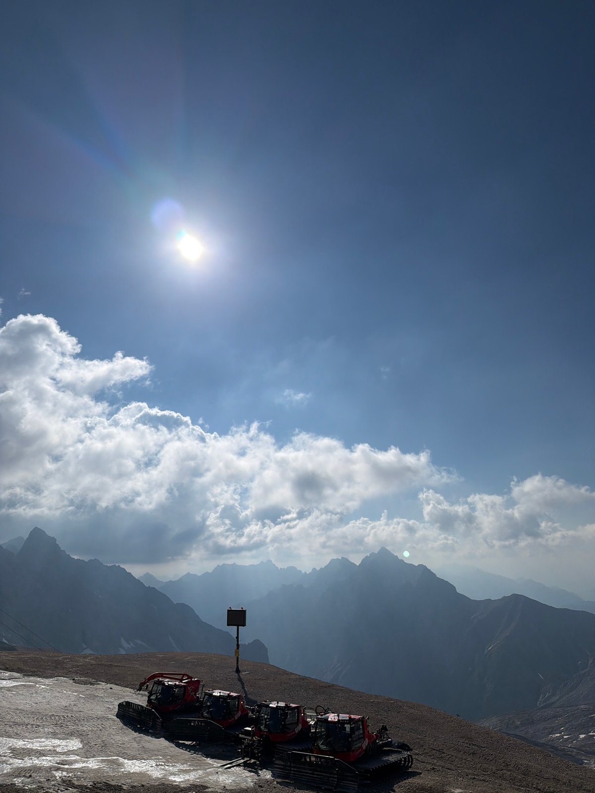 Morning at the Zugspitze: alpine views, snow groomers, and a Red Bull
