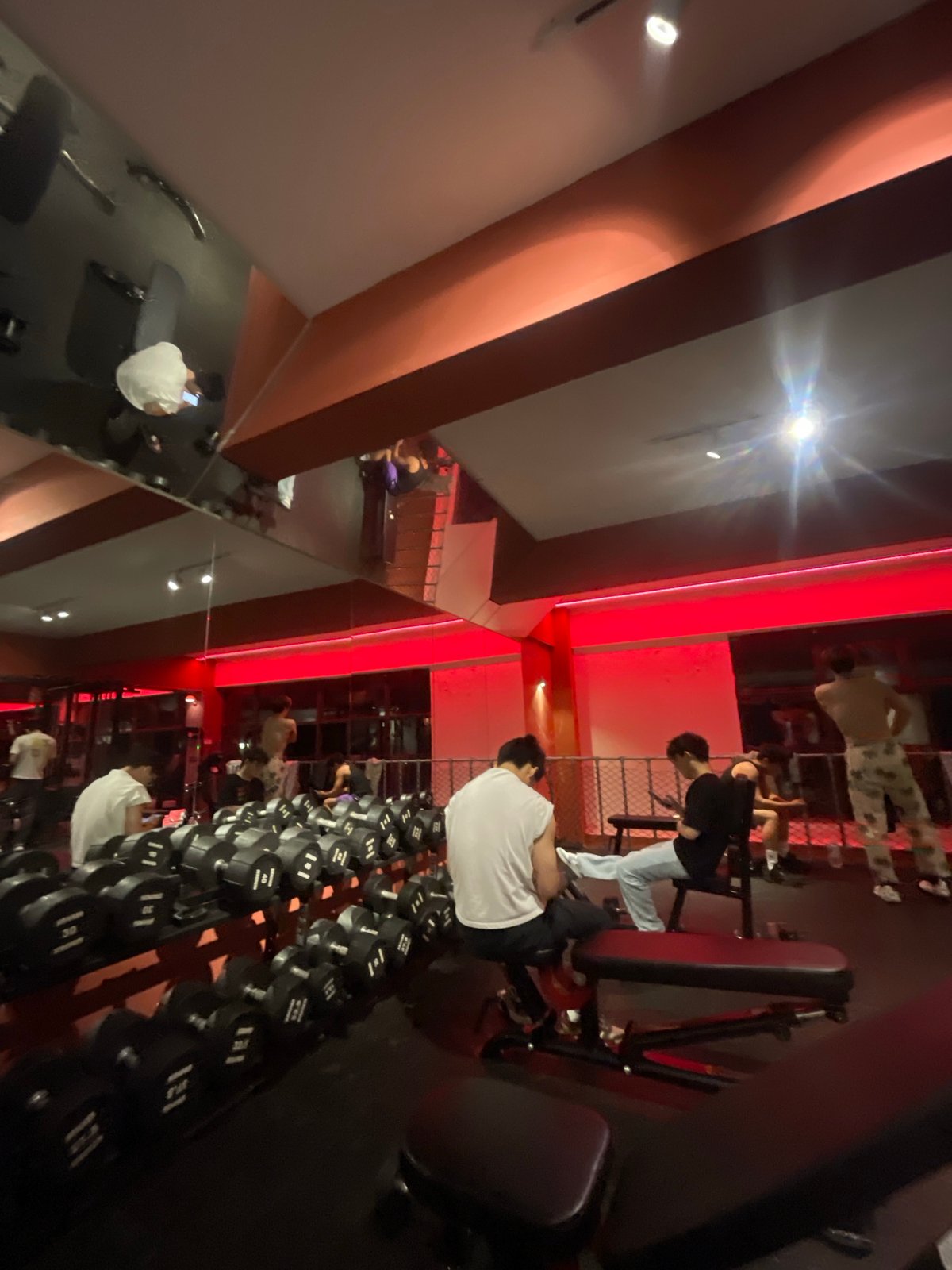 Young men exercise at red-lit gym in Chongqing tech zone