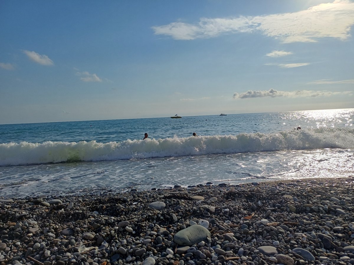 Sunny afternoon on Sochi's Black Sea pebble beach