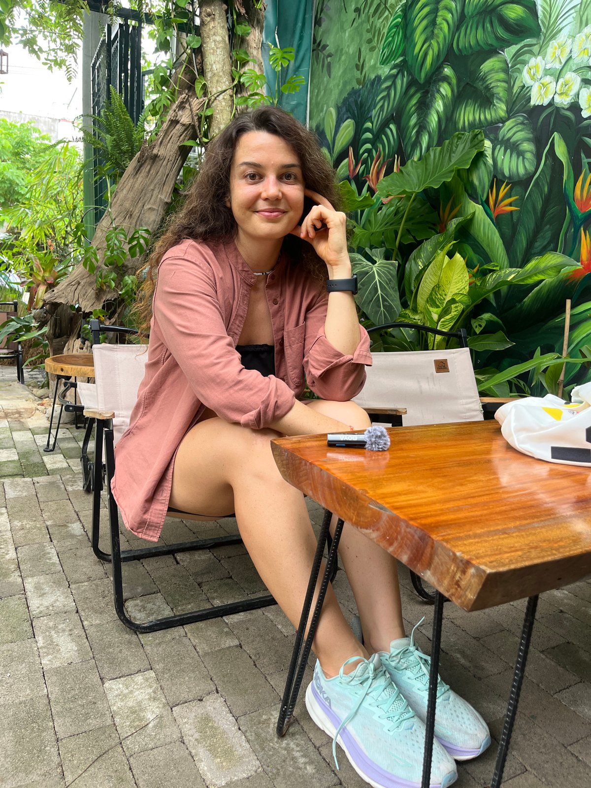 Relaxed morning at a mural-backed outdoor café in Phu Thuy Ward