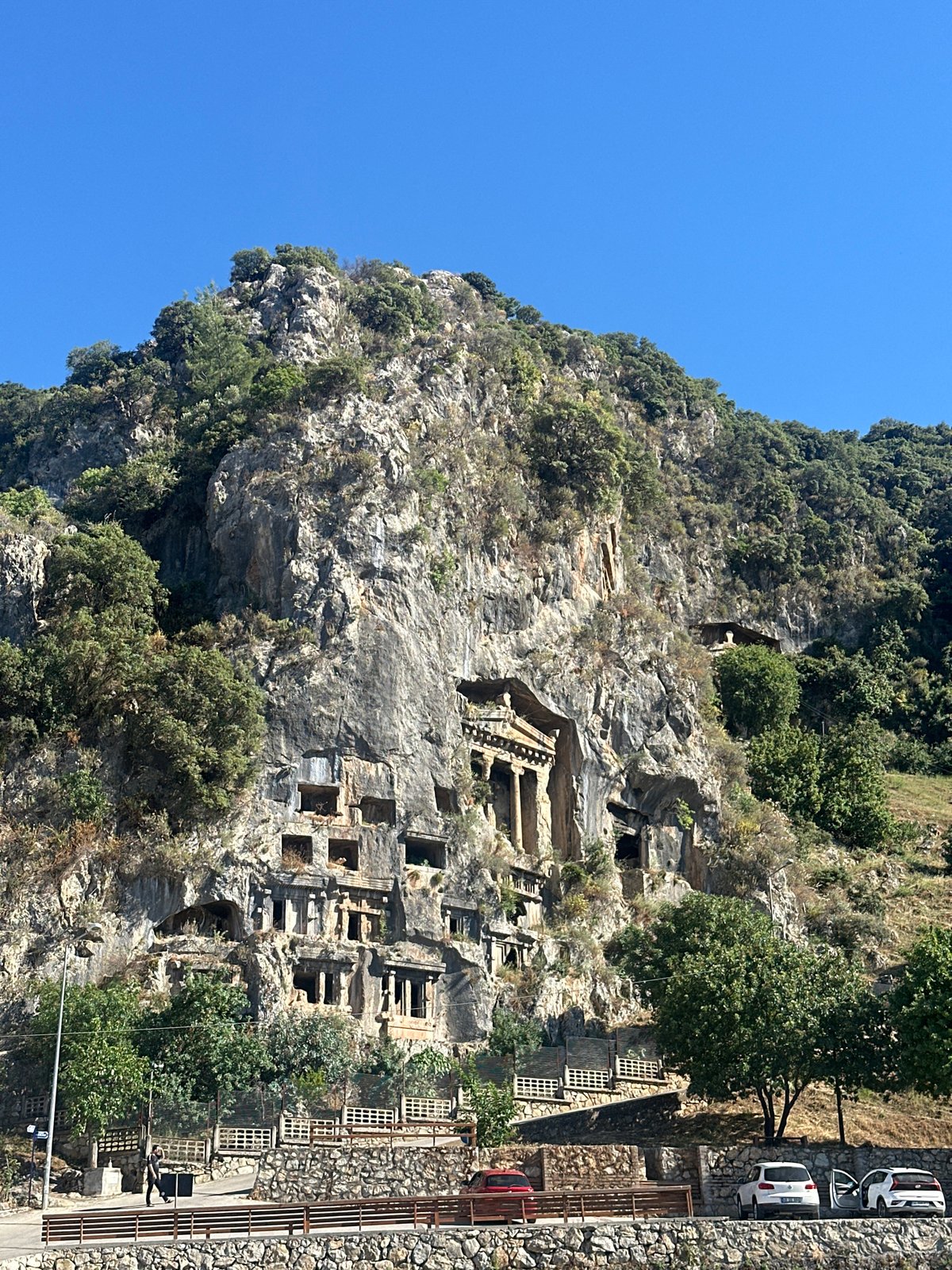 Tourist visits ancient rock tombs in Fethiye, Turkey