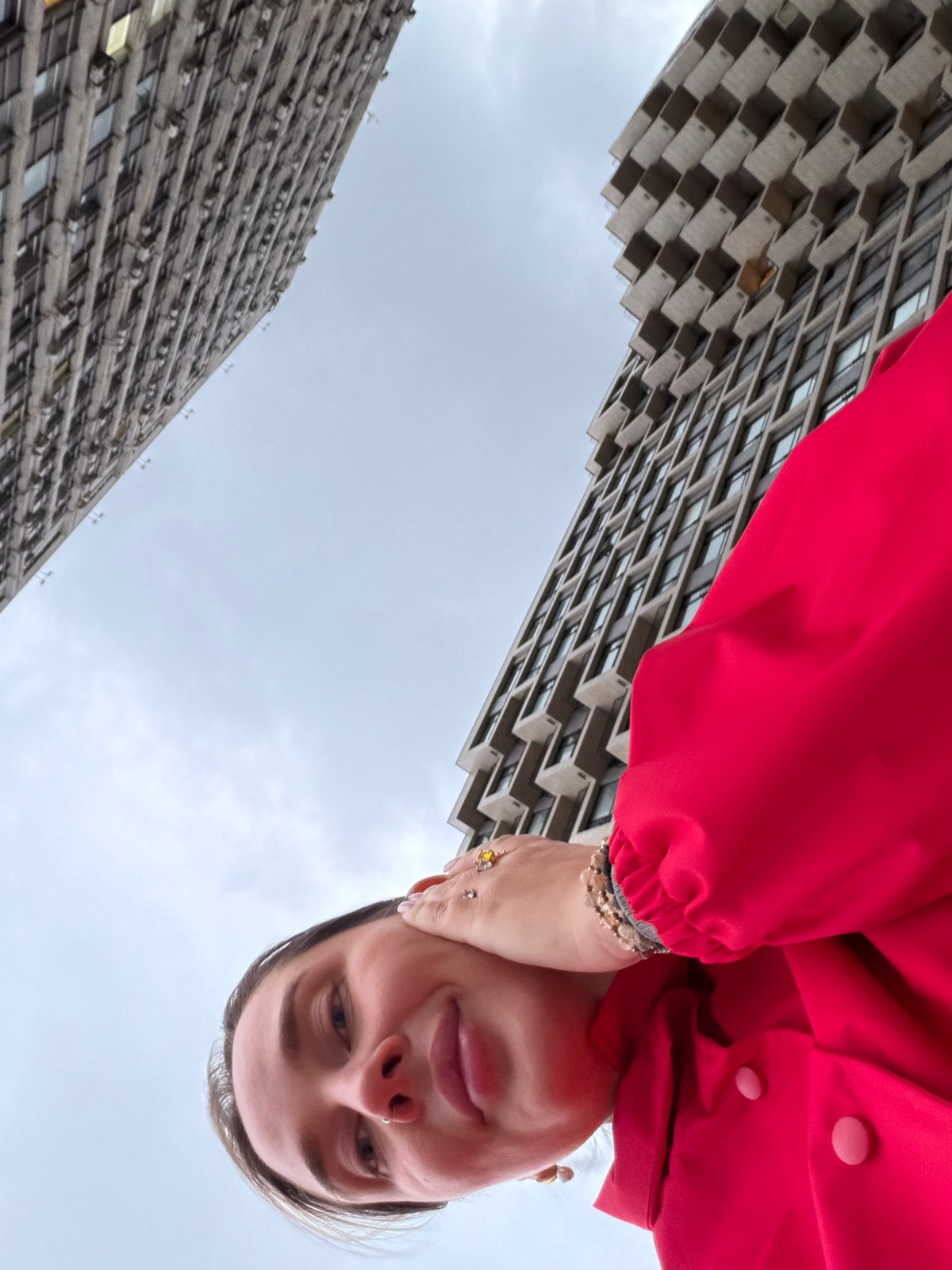 Rotated street photography captures person between Moscow buildings