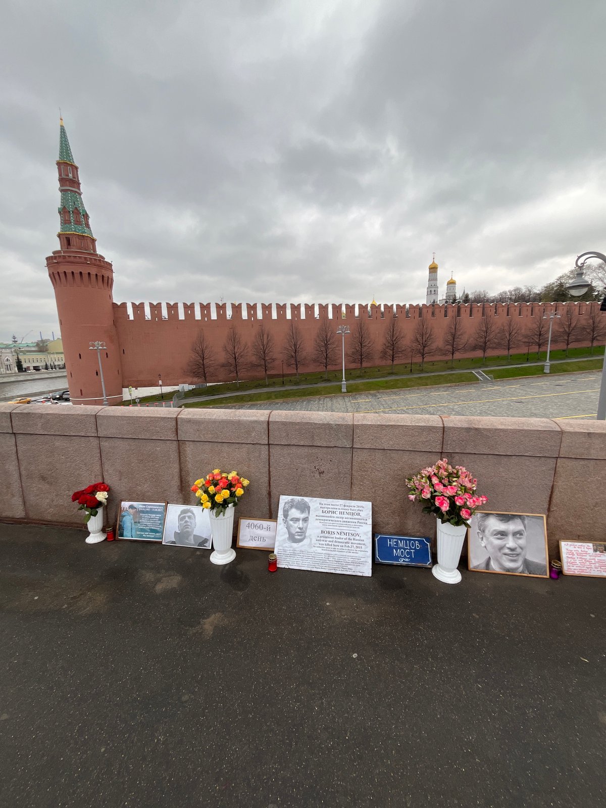 Man in orange tracksuit lies on Red Square cobblestones