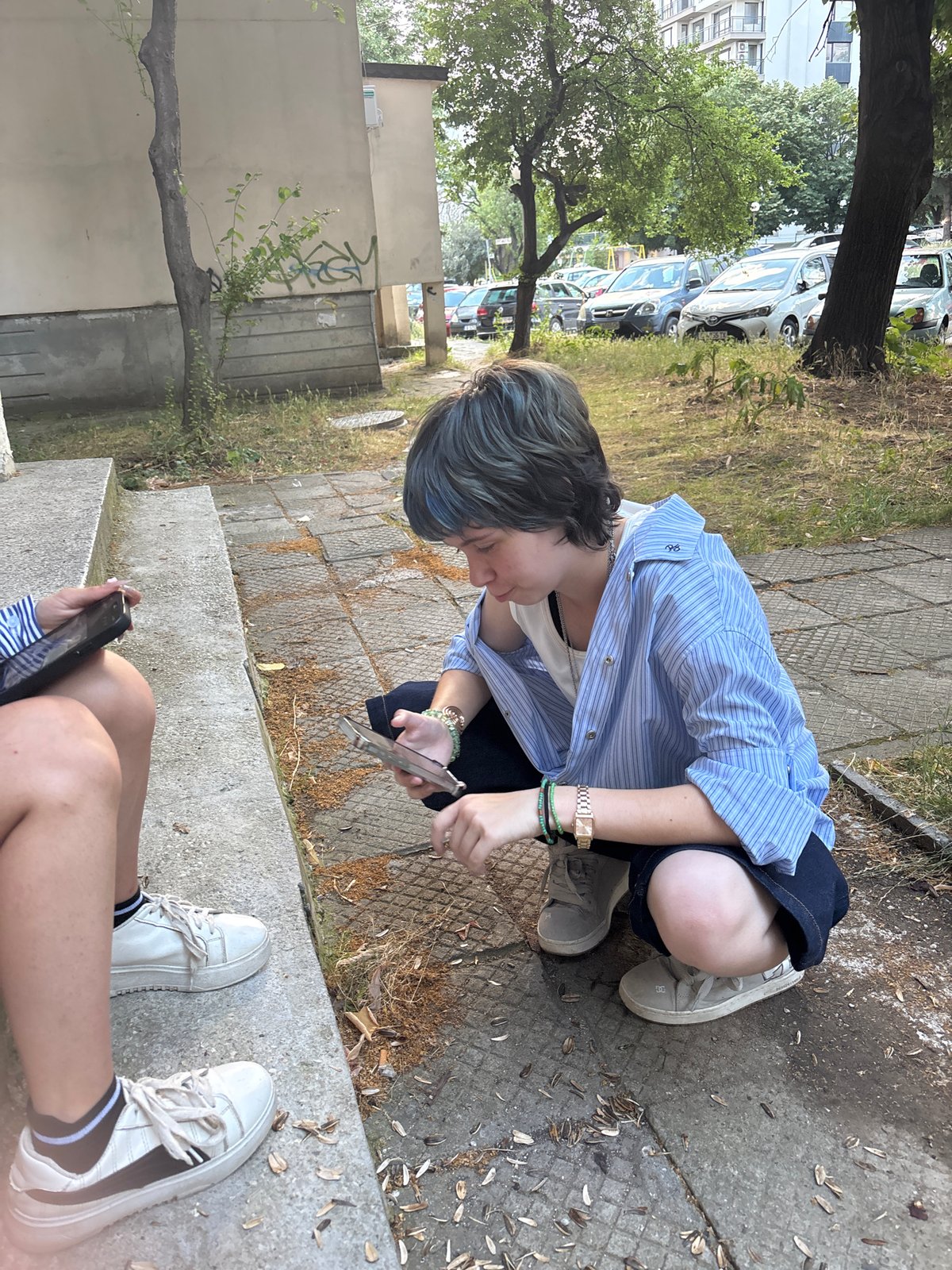 Crouched on pavement near concrete steps in Varna