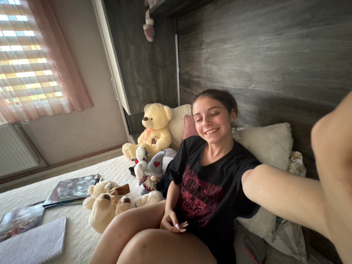 Woman Takes Relaxed Selfies on Bed in Bulgarovo