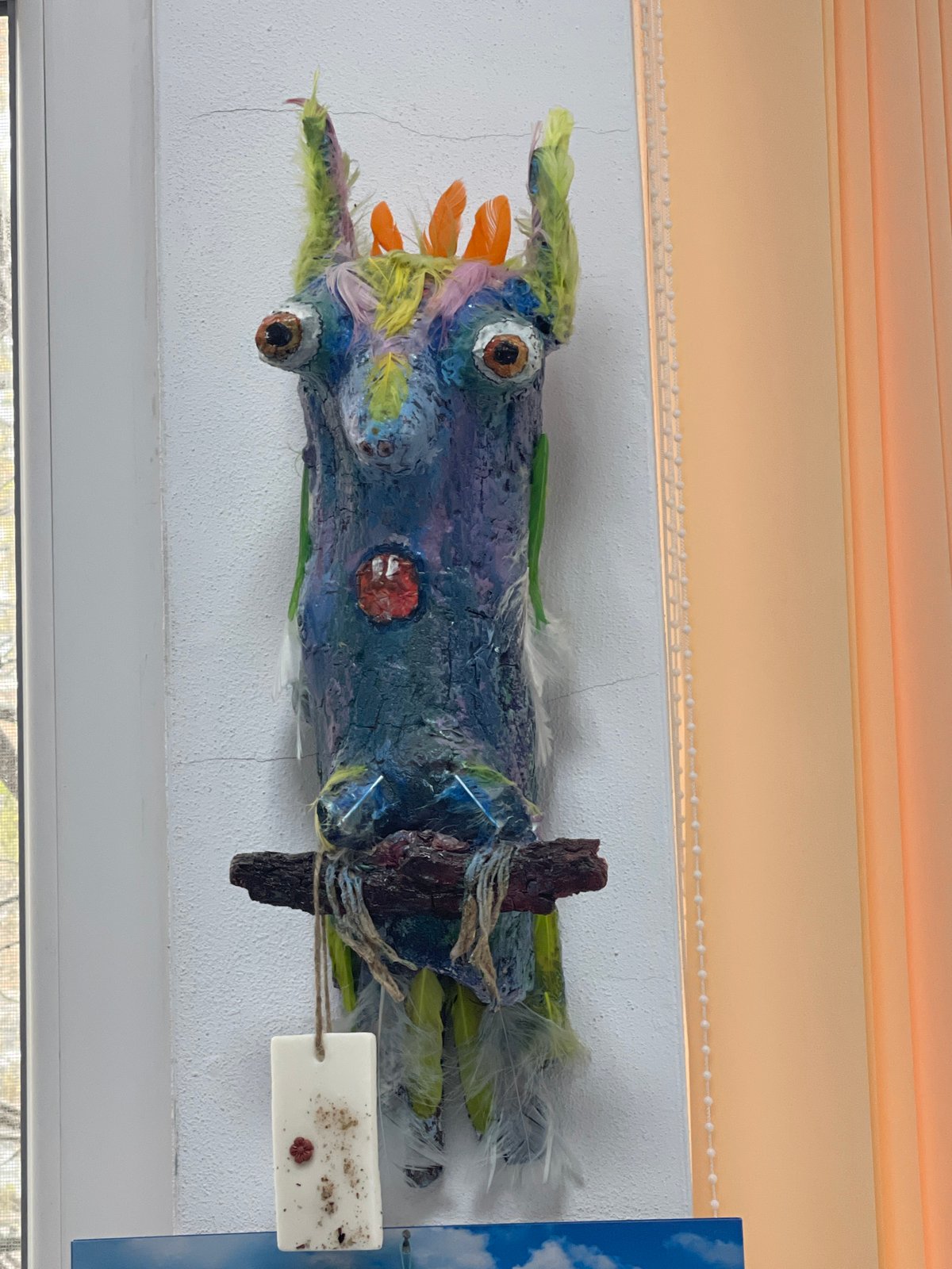 Colorful handcrafted driftwood art displayed on wall in Sevlievo