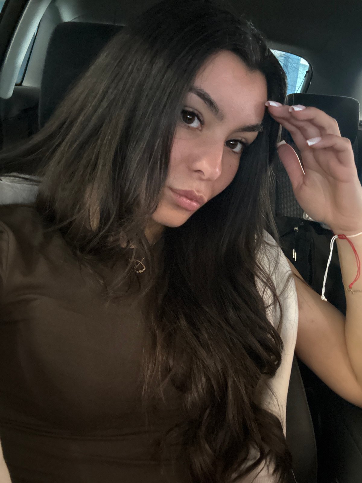 Woman takes selfies in car passenger seat in Varna