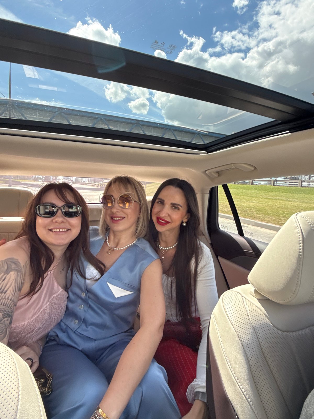 Three women take selfie in car in Moscow