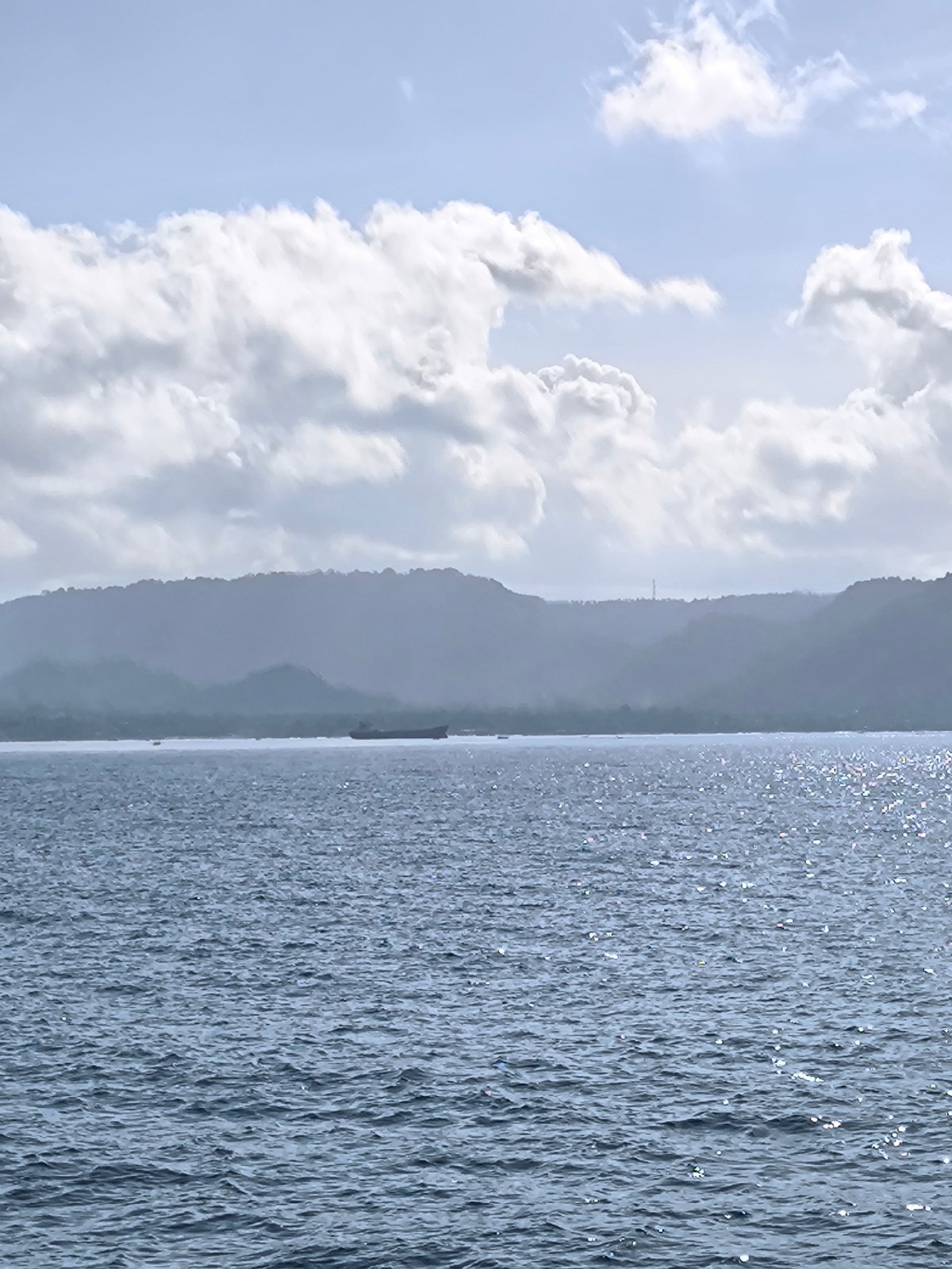 Boat passengers enjoy sunny morning journey off Indonesian coast
