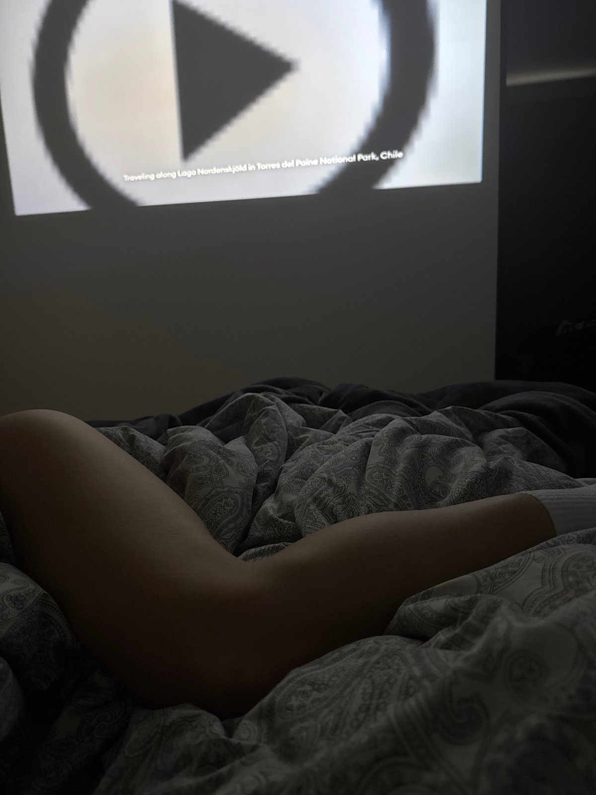 Person watches geometric video content in bed Monday evening