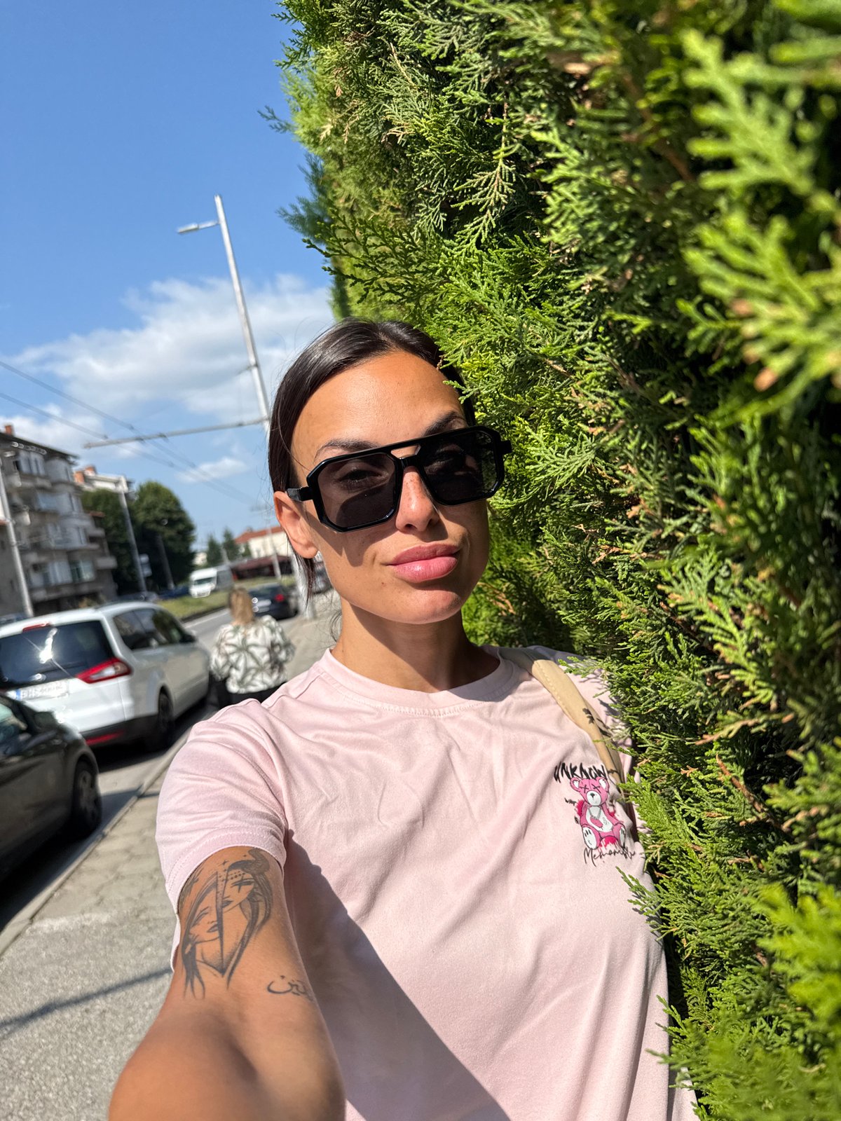 Outdoor selfie beside a green hedge in Pleven, Bulgaria
