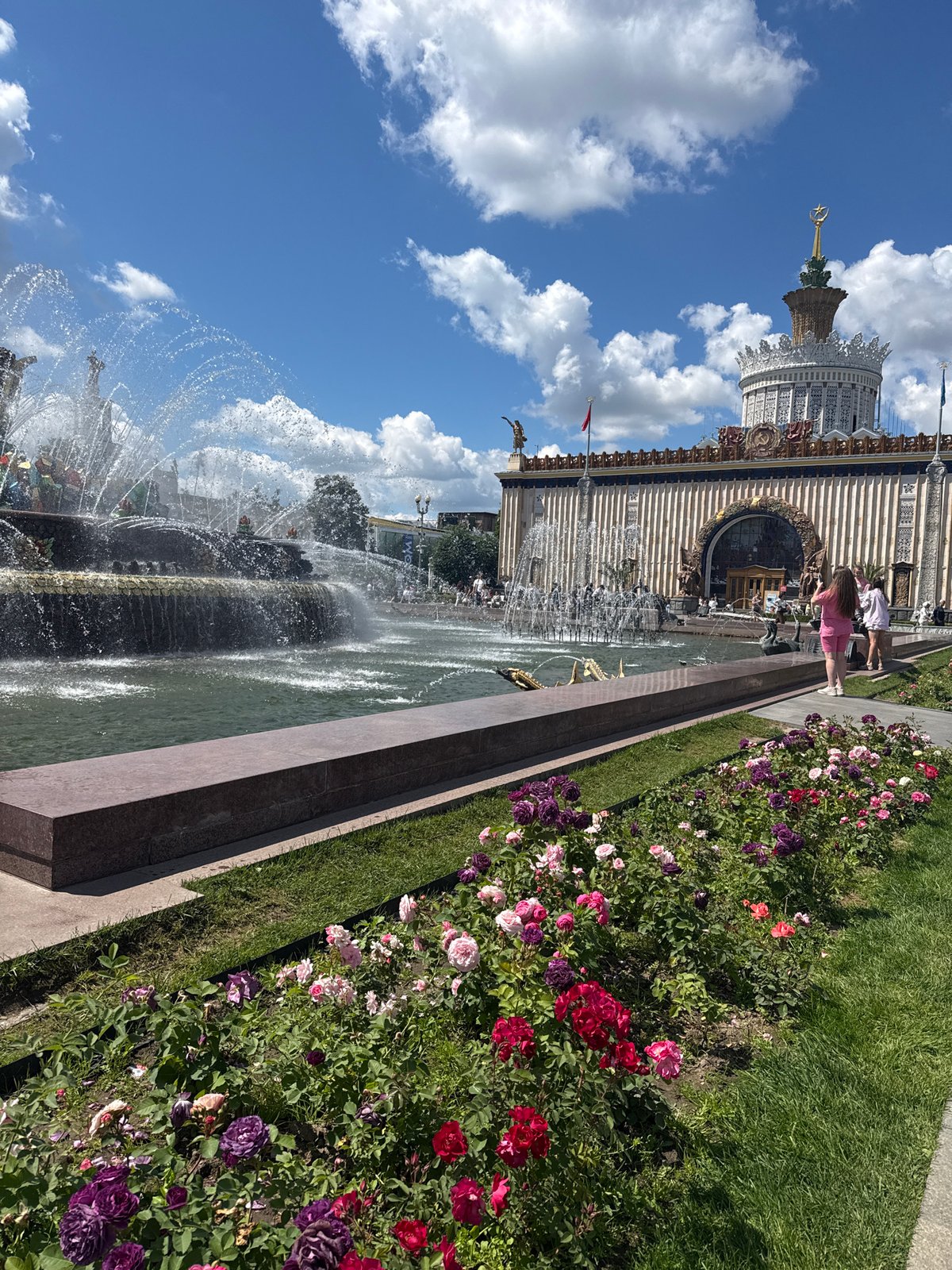 Summer morning at VDNKh: fountains, flowers, craft market, and reenactors