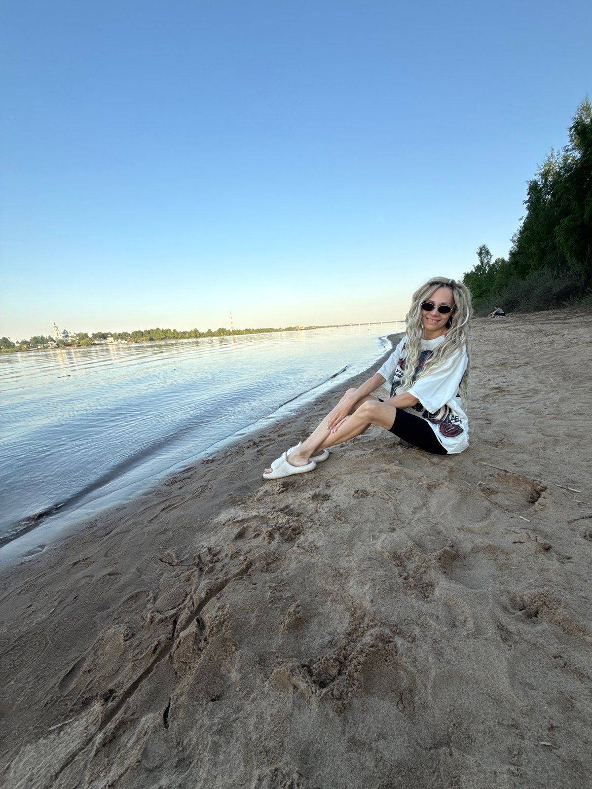 Woman enjoys riverside afternoon in Rusanovo, Russia