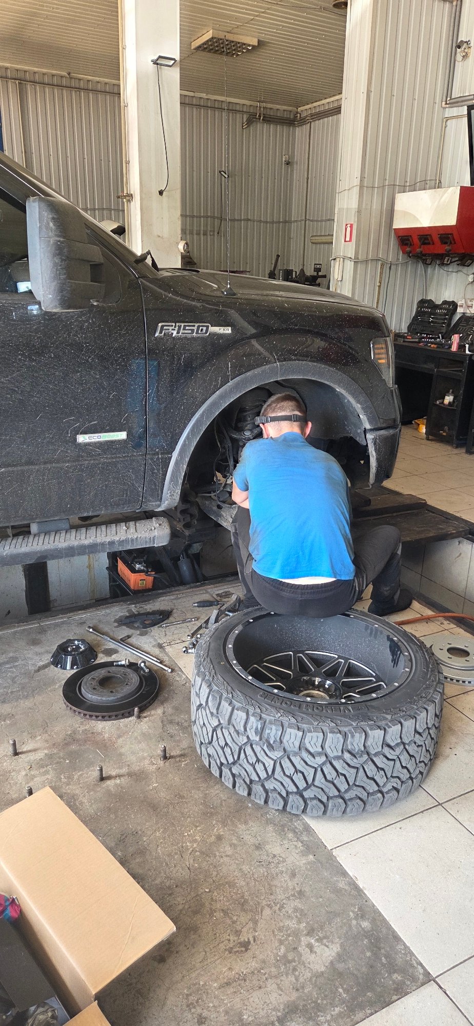Auto service activity across a Donetsk vehicle repair strip