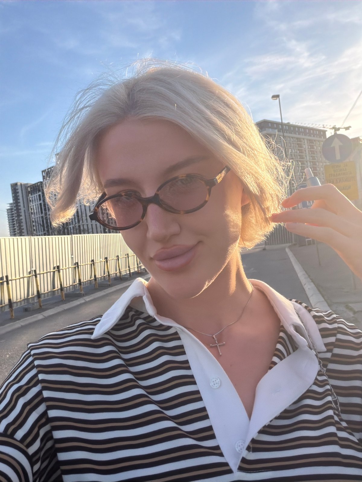 Woman takes selfies on sunny afternoon in Belgrade