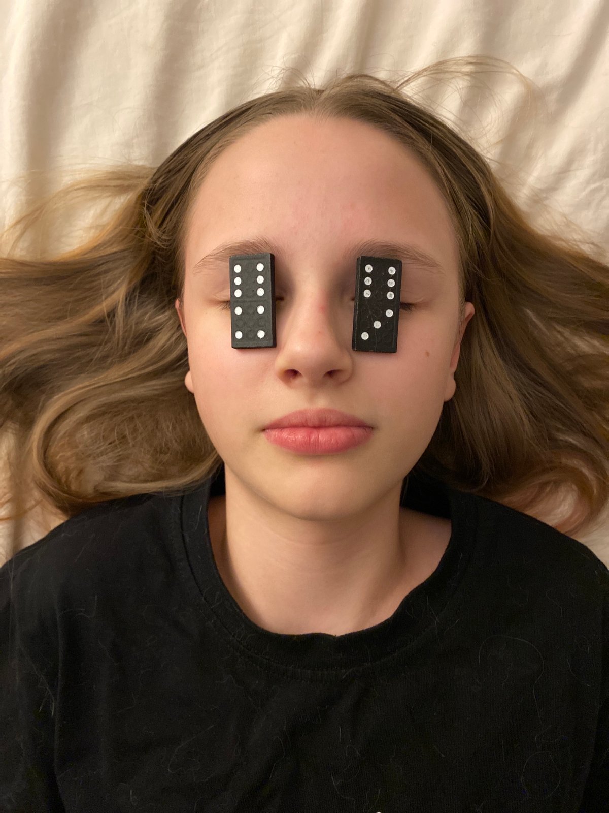 Person photographed with dominoes covering eyes in Yekaterinburg