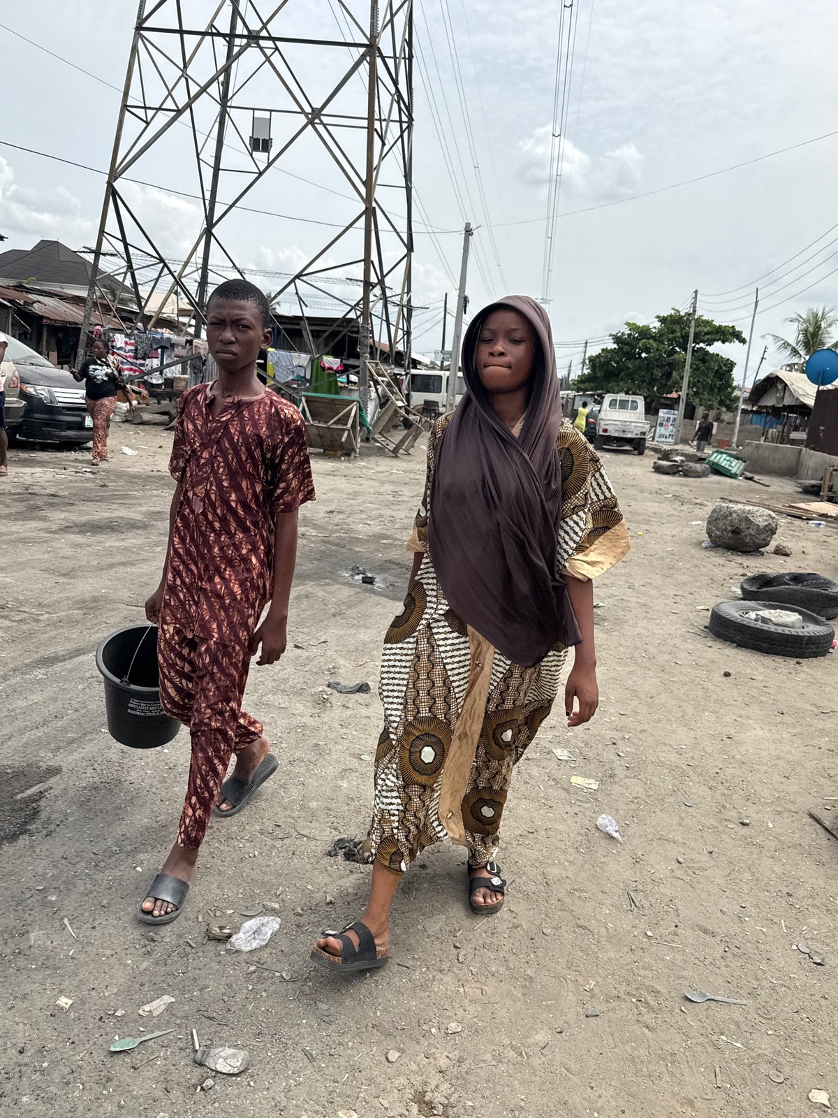 Two people spotted on dirt road in Ado, Nigeria