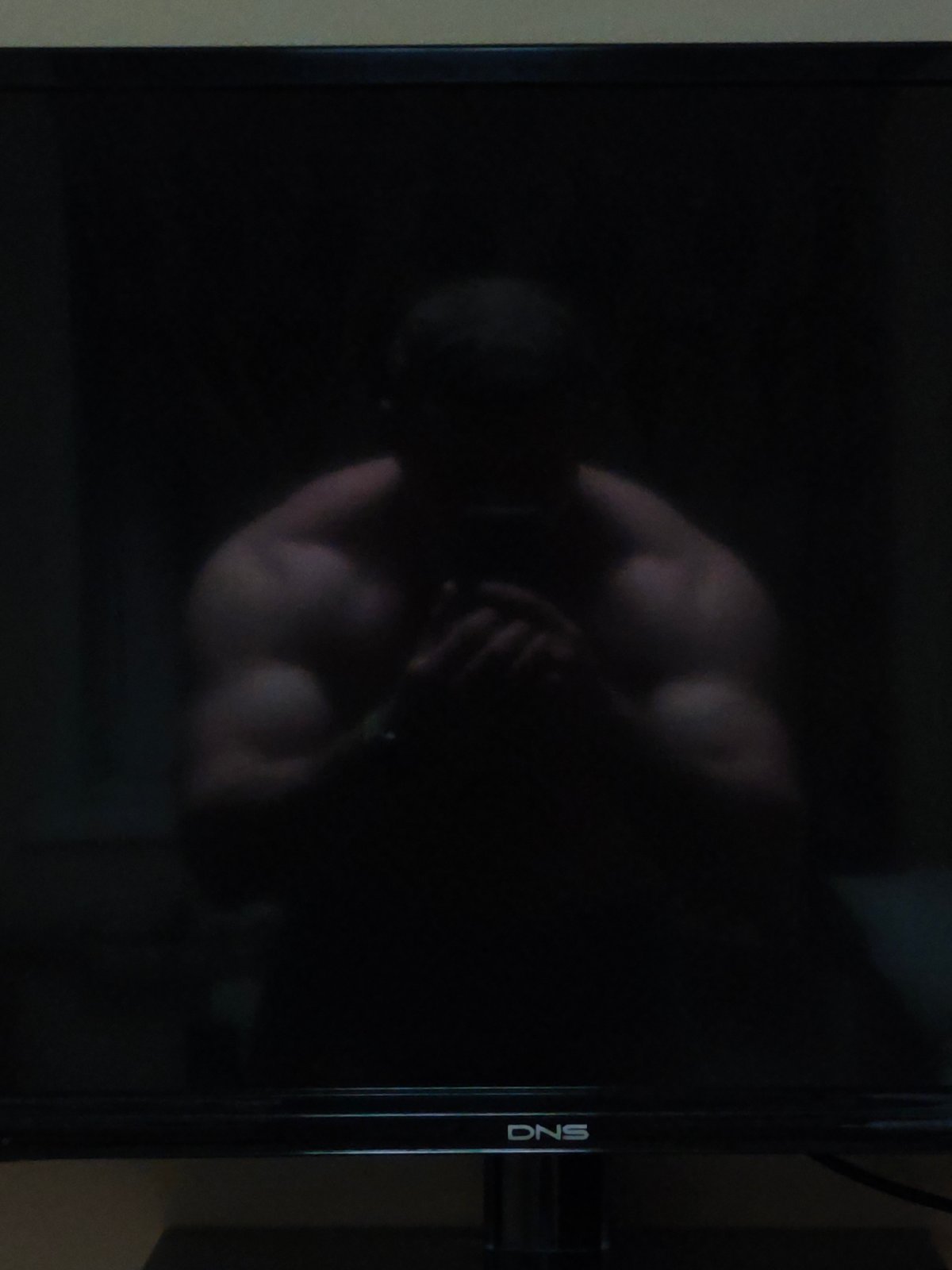 Person's reflection captured in dark TV screen in Russia
