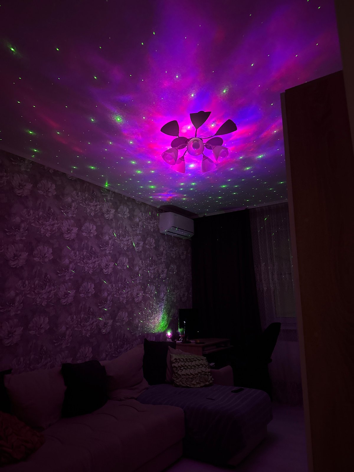 Person reads Russian book under colorful ambient lighting