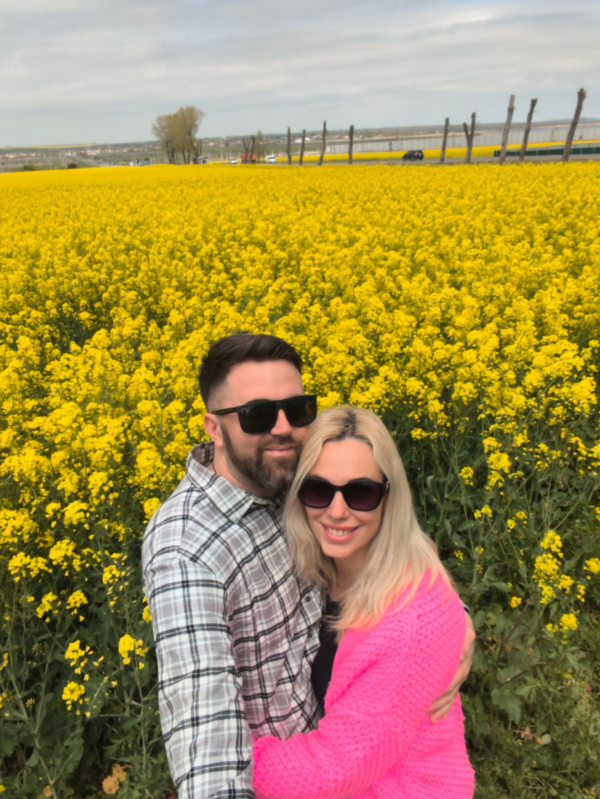 Couple embraces in Ukrainian flower field
