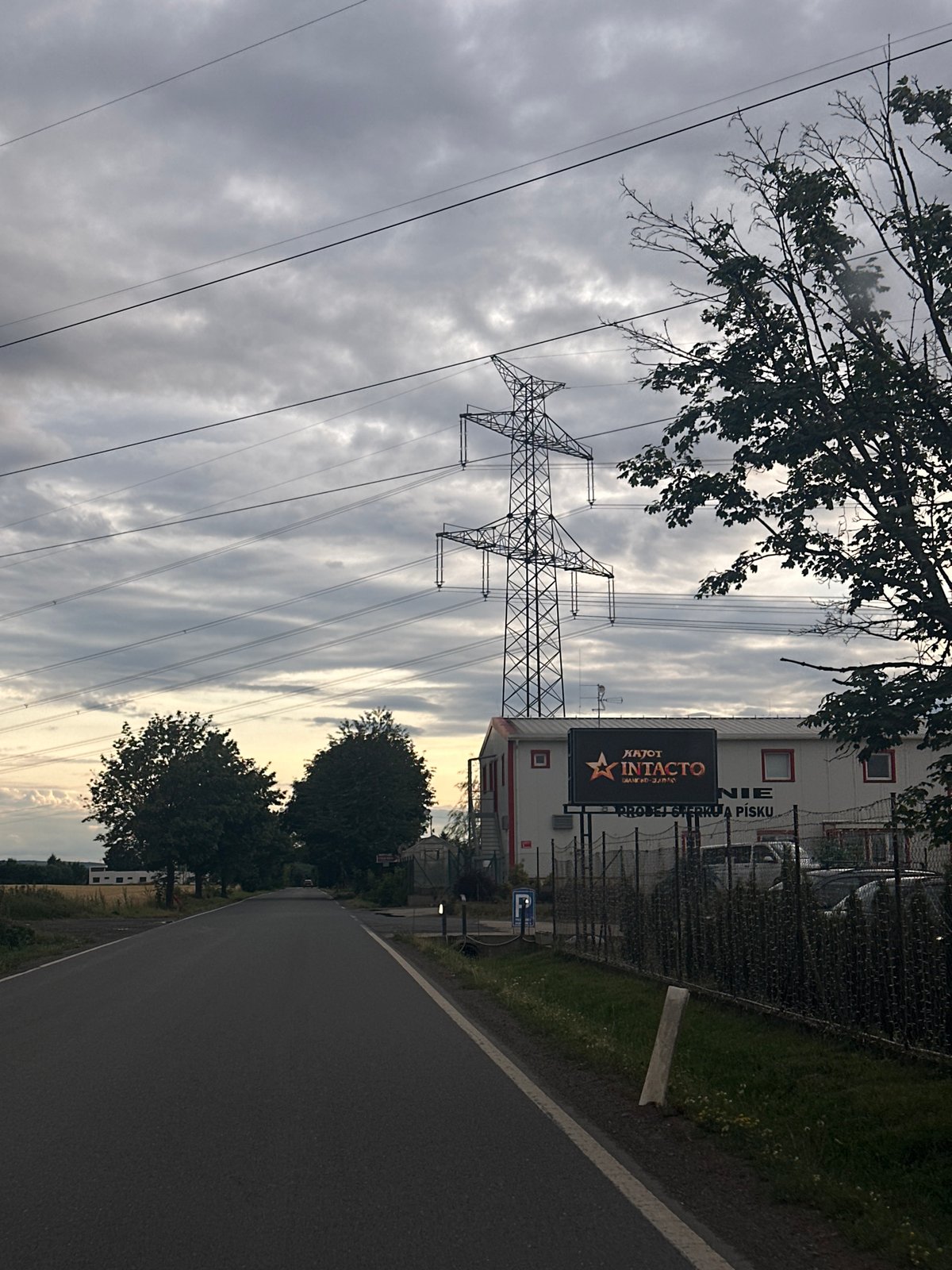 Overcast streets and rural outskirts under heavy clouds