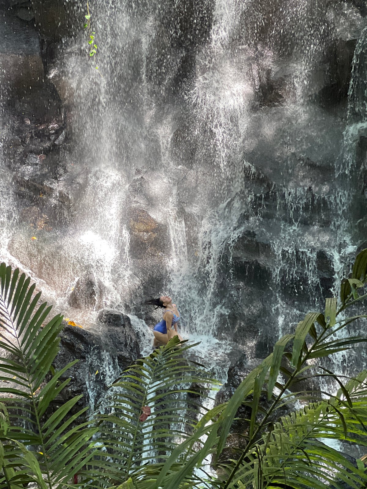 Tourists enjoy early morning waterfall activities in Gianyar, Indonesia