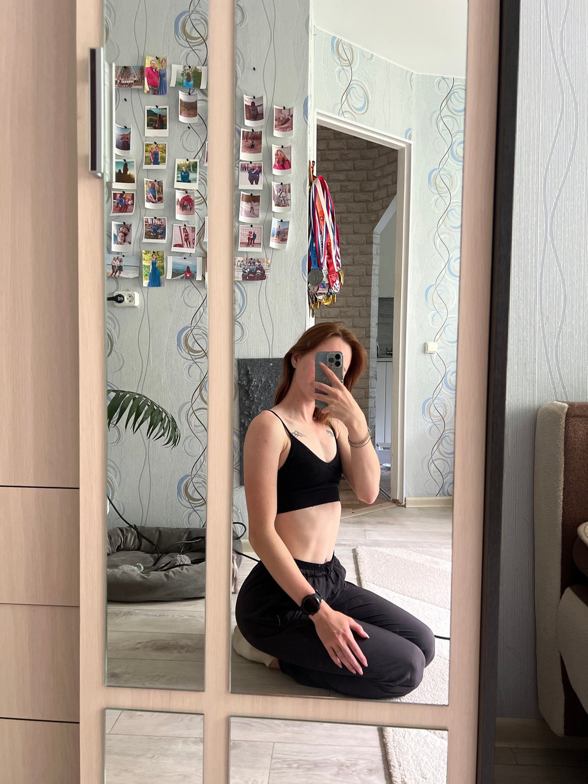 Woman takes mirror selfies with cat in Chaikovsky bedroom